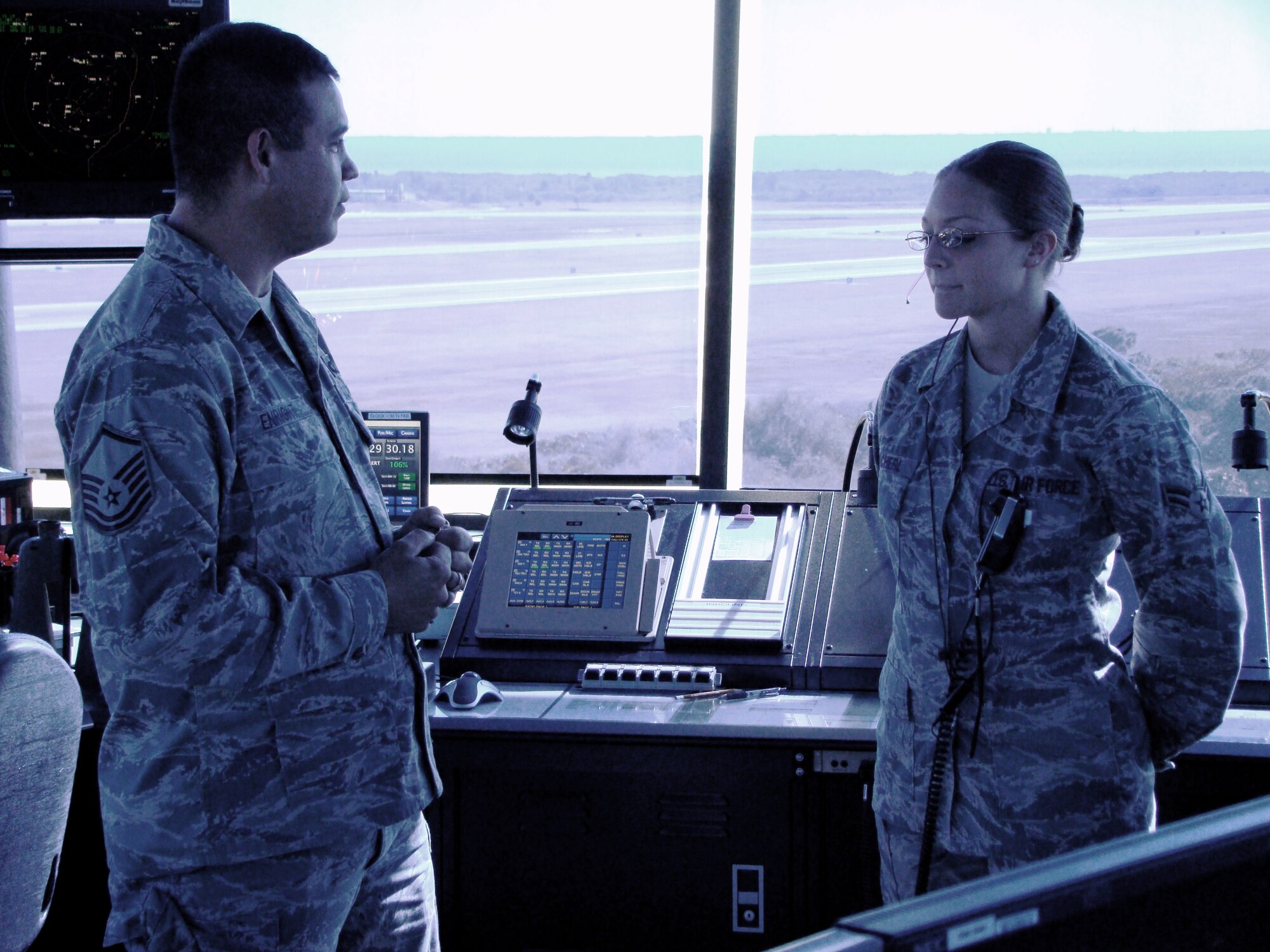 Senior Airman Kristina Zacherl (right), air traffic controller for the 6th Operations Support Squadron, meets with a co-worker during operations at her squadron at MacDill Air Force Base, Fla., in 2010. On April 1, 2011, Airman Zacherl was named the 2010 Air Mobility Command Airman of the Year. (U.S. Air Force Photo)

