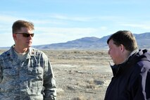 UTAH TEST AND TRAINING RANGE, Utah -- Air Force Reserve Maj. Karl Haagsma, a research entomologist assigned to the 910th Aerial Spray Flight, talks with Jeff Rhodes, associate editor of Lockheed Martin's Code One magazine here, March 31. Mr. Rhodes is interviewing Maj. Haagsma and a team of 910th Airlift Wing Citizen Airmen about their mission to apply to more 1200 acres of target areas here from a Lockheed Martin-built C-130 Hercules cargo aircraft. The 910th, based at Youngstown Air Reserve Station, Ohio, home to the Department of Defense's only large-area fixed wing aerial spray unit, has been tasked, through April 7, with controlling Halogeton, an evasive weed that can hamper bombing test evaluations and unexploded ordinance recovery. U.S. Air Force photo by Master Sgt. Bob Barko Jr.