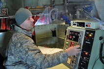 HILL AIR FORCE BASE, Utah -- Air Force Reserve Tech. Sgt. Jeremy Rogers, an aerial spray maintainer assigned to the 910th Aerial Spray Maintenance Flight, operates the control panel of a Modular Aerial Spray System (MASS) on the cargo deck of a C-130 Hercules cargo aircraft parked on a flight line ramp here, March 30. Sergeant Rogers and a team of 910th Airlift Wing Citizen Airmen will use the MASS to apply an herbicide mixture to more than 1200 acres of target areas on the Utah Test and Training Range (UTTR). The 910th, based at Youngstown Air Reserve Station, Ohio, home to the Department of Defense's only large-area fixed wing aerial spray unit, has been tasked, through April 7, with controlling Halogeton, an evasive weed that can hamper bombing test evaluations and unexploded ordinance recovery. U.S. Air Force photo by Master Sgt. Bob Barko Jr.