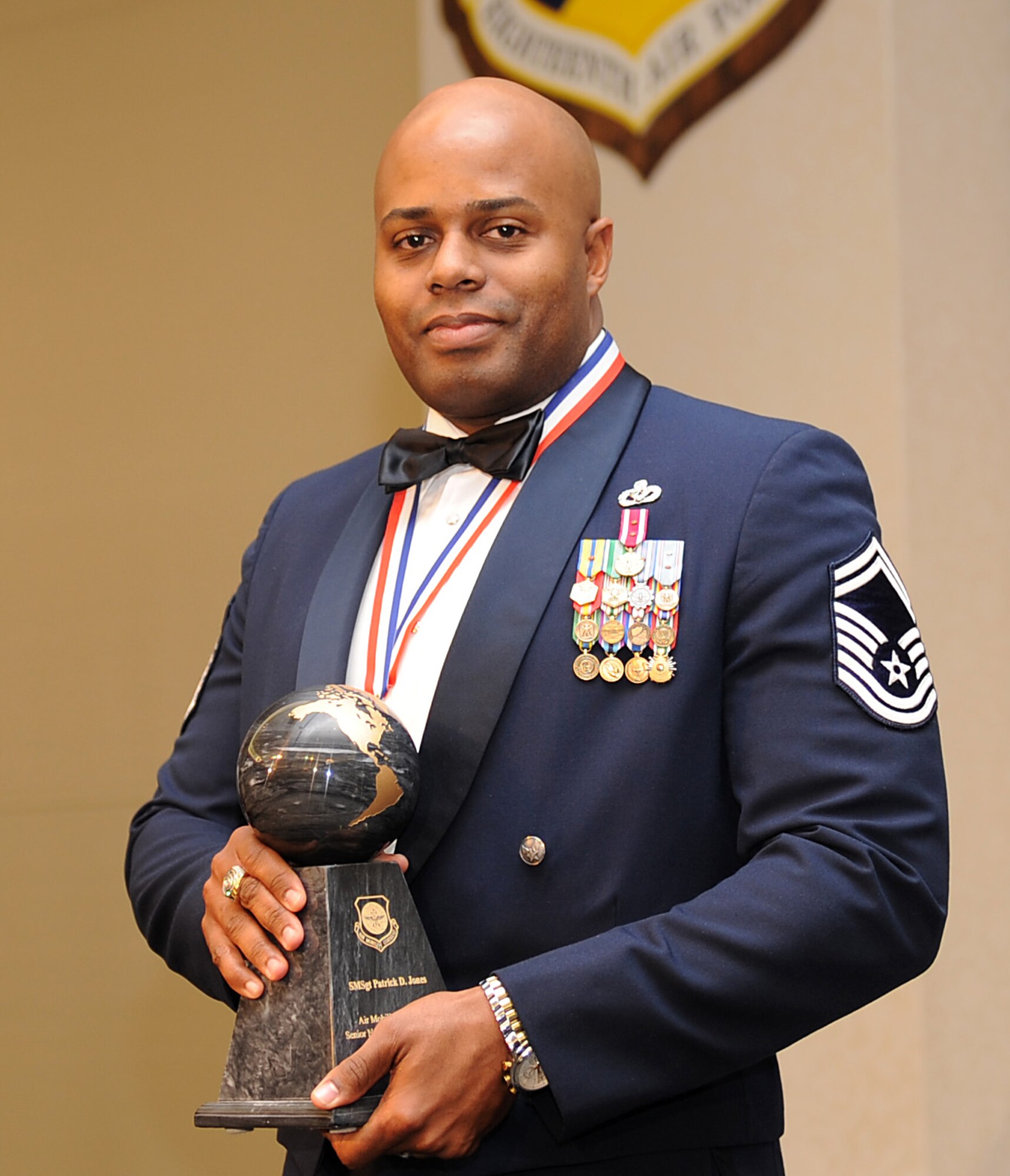 Senior Master Sgt. Patrick Jones, from the 375th Civil Engineer Squadron at Scott Air Force Base, Ill., holds his award after being named the 2010 Air Mobility Command Senior NCO of the Year during AMC's Outstanding Airmen of the Year banquet April 1, 2011, at Scott Air Force Base, Ill. (U.S. Air Force Photo/Airman 1st Class Divine Cox)
