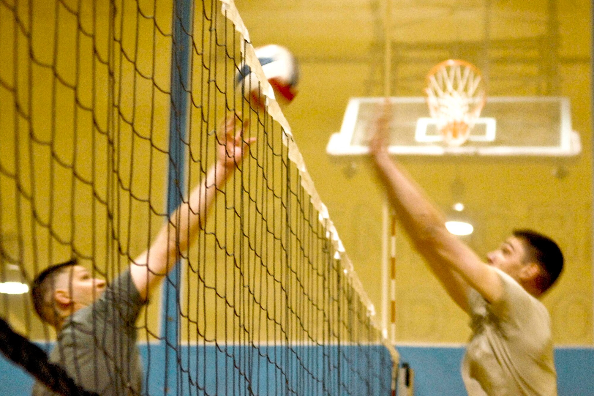 JOINT BASE ELMENDORF-RICHARDSON, Alaska --A member of the 517th Airlift Squadron intramural volleyball team spikes as a defender on the U.S. Army Corps of Engineers team defends durin a game April 1. (U.S. Air Force photo/Airman 1st Class Jack Sanders)