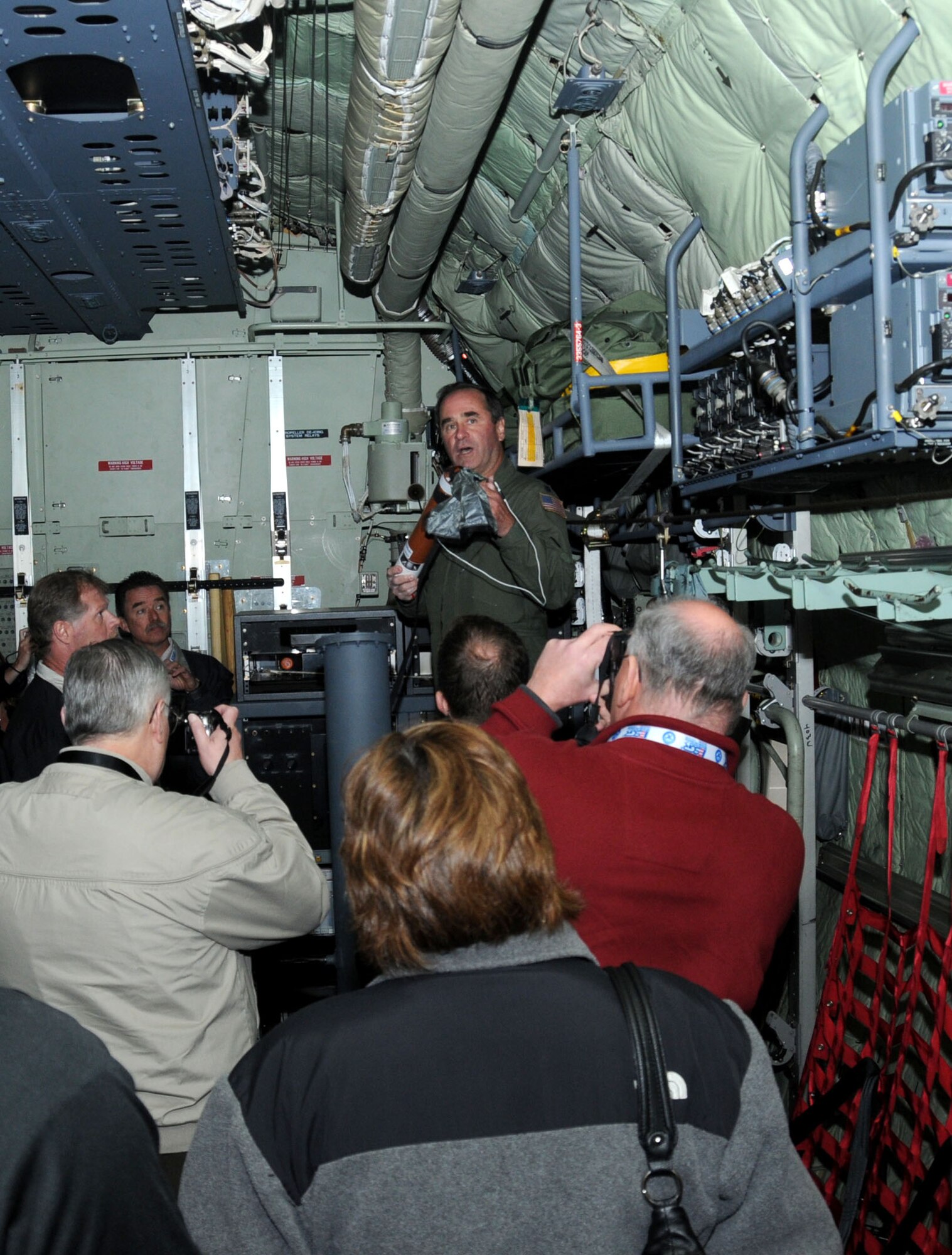 Lt. Col. Rich Harter, 53rd Weather Reconnaissance Squadron, gives a briefing on how
weather data is collected during an Employer Support of the Guard and Reserve tour for employers from Colorado and Arkansas, March 31. The briefing took place inside the belly of a C-130-J weather reconnaissance aircraft.  (U.S. Air Force photo by Kemberly Groue)