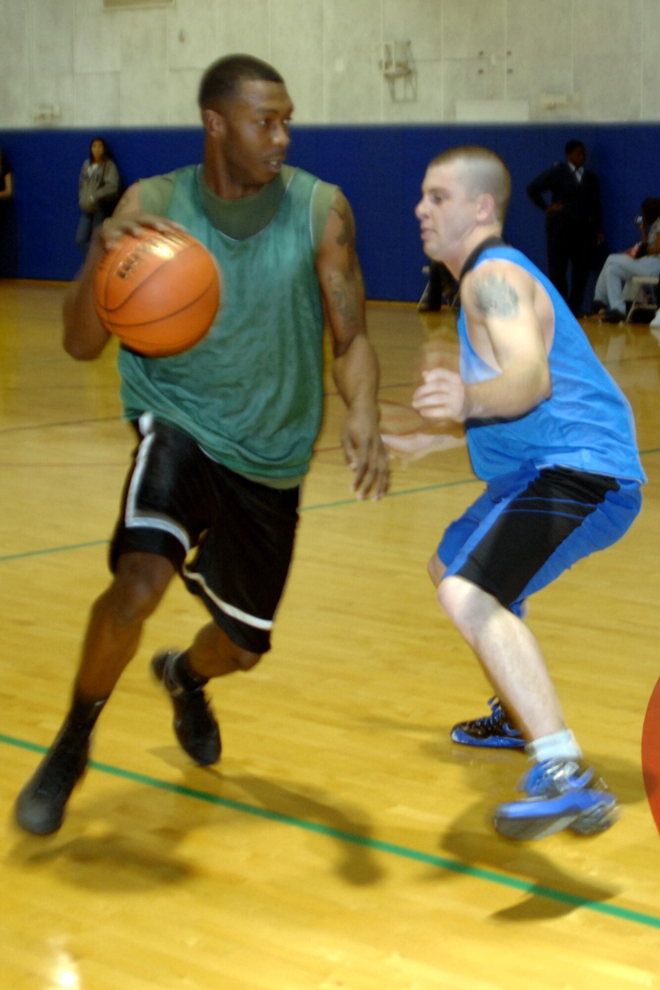 GRISSOM AIR RESERVE BASE, Ind.  -- Travis White, of the Marines is defended closely by Derek Bartee, 434th Seasoning Training Flight, in the finals of the annual basketball tournament. The Airmen put the clamps on the Marines down the stretch and won 46-40. (U.S. Air Force photo/Tech. Sgt. Douglas Hays)