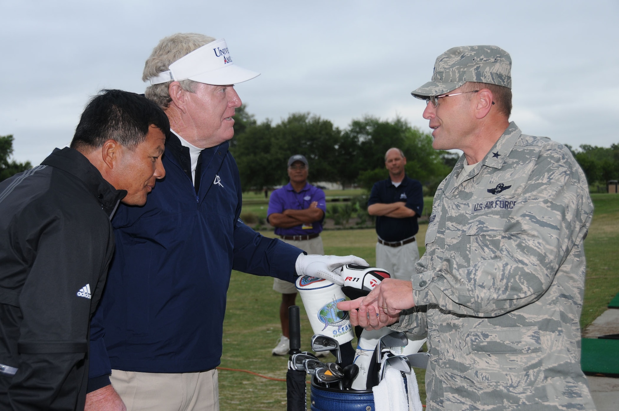 From left, pro golfers Ching Soon Luc and Andy Bean receive 81st Training Wing coins from Brig. Gen. Andrew Mueller during a free clinic they gave March 30 at the Bay Breeze Golf Course.  The clinic preceded the Mississippi Gulf Resort Classic at Fallen Oak Golf Course in Saucier last weekend.  (U.S. Air Force photo by Kemberly Groue)