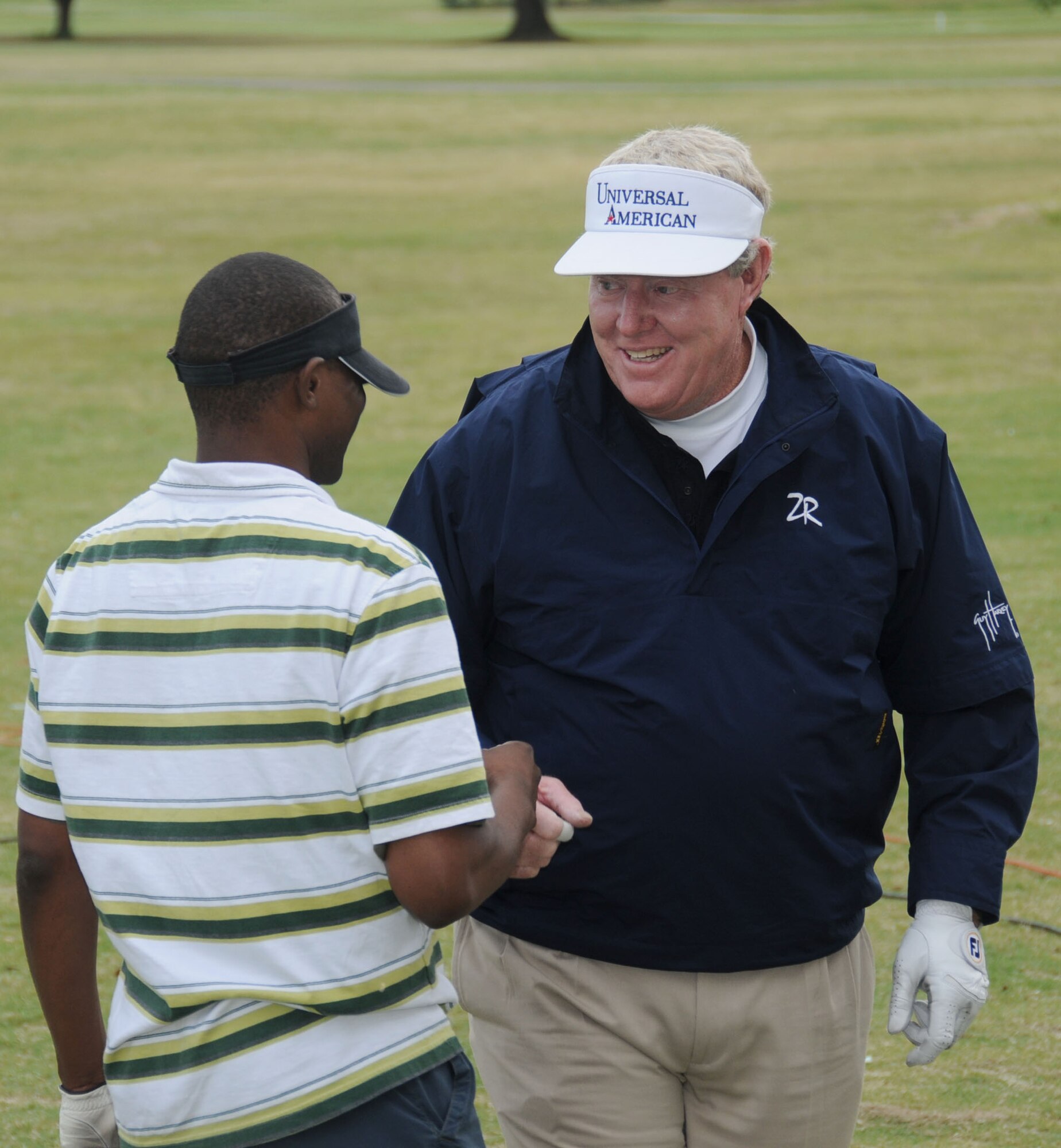 Lentrell Hill, left, 338th Training Squadron student, gets some golfing pointers from pro golfer Andy Bean during a free golf clinic March 30 at Bay Breeze Golf Course.  (U.S. Air Force photo by Kemberly Groue)