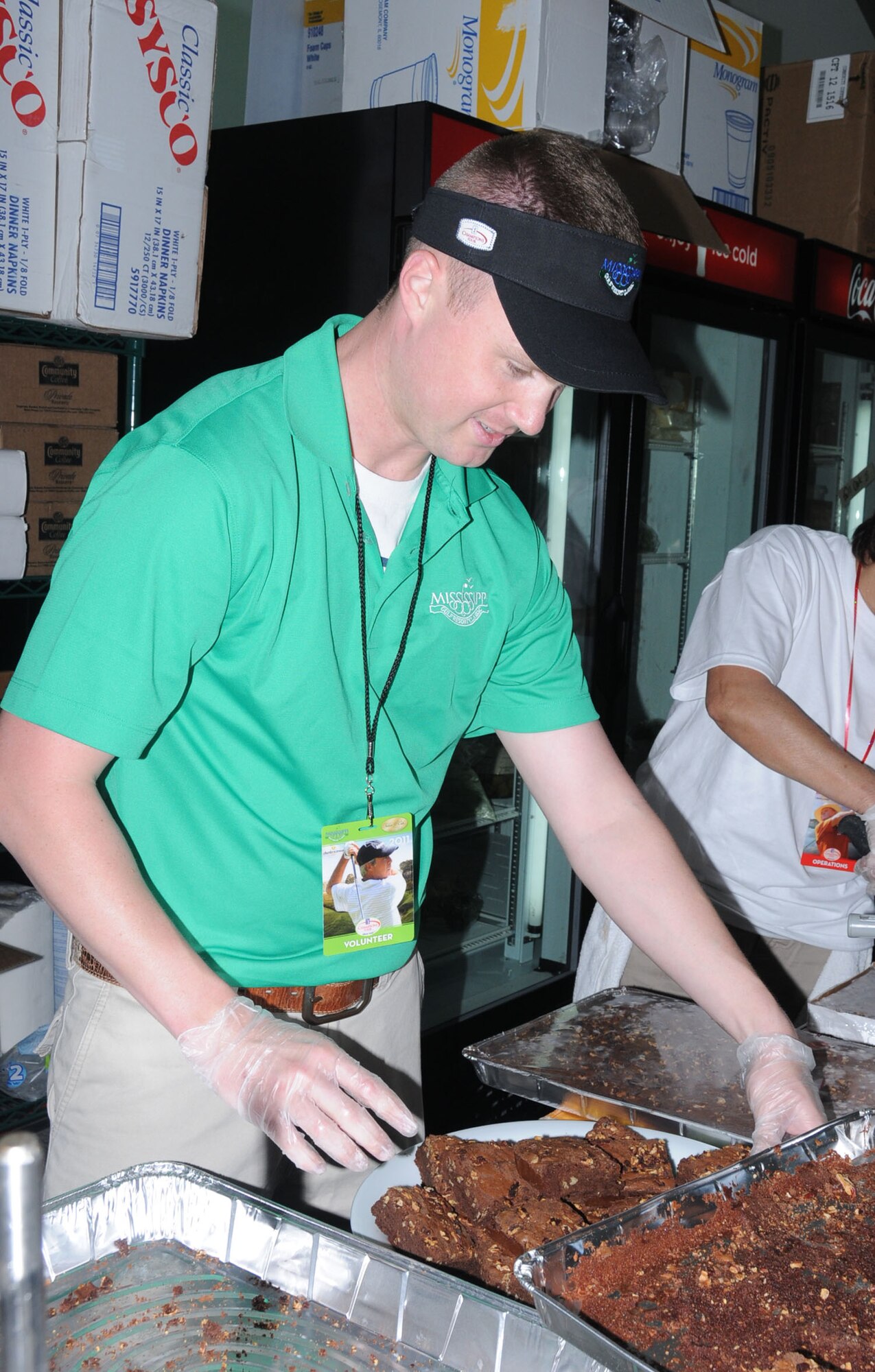 Eric Knight, 81st Surgical Operations Squadron, puts brownies on a platter for the golfers, Friday.  (U.S. Air Force photo by Kemberly Groue)