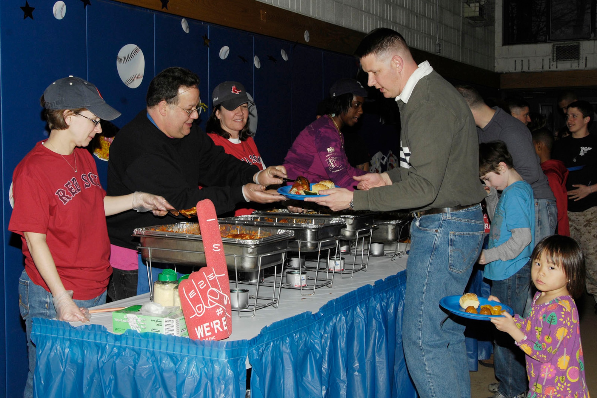 HANSCOM AIR FORCE BASE, Mass. - Laurel Wironen (left) and Coletha Cox (middle) serve pasta to Lauren Decker during Family Pasta Night at the Youth Center on March 31. All Hanscom families were invited to the special meal to help kick off Month of the Military Child. (U.S. Air Force photo by Linda LaBonte Britt)