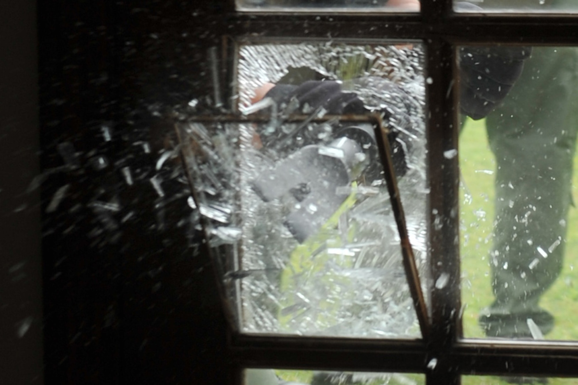 SEYMOUR JOHNSON AIR FORCE BASE, N.C. -- A Duplin County Sheriff's Office special response team member uses a halogen tool to break through a glass door here in base housing, April 5, 2011. The 4th Security Forces Squadron and Duplin County Sheriff's Office special response team members completed a joint operation training exercise to improve their tactical skills. Duplin County Sheriff's Office, located in Kenansville has a 20 member special response team. (U.S. Air Force photo/Senior Airman Whitney Lambert) (RELEASED)