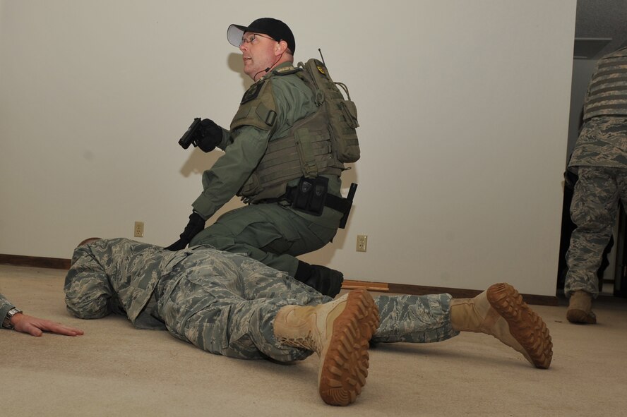 SEYMOUR JOHNSON AIR FORCE BASE, N.C. -- A Duplin County Sheriff's Office special response team member pins down Staff Sgt. Tommy Dailey while searching a room during a training exercise at Seymour Johnson Air Force Base, N.C., April 5, 2011. Sergeant Dailey is playing the role of an assailant to ensure the first responders know how to properly secure aggressors. Sergeant Dailey is a 4th Security Forces Squadron Combat Arms Training and Maintenance instructor and is from Desoto, Ill. (U.S. Air Force photo/Senior Airman Whitney Lambert) 