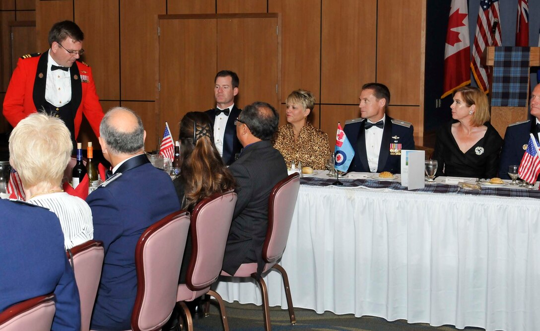Maj. Mark Fathers (standing), President of the Mess Committee, prepares to give a toast during the 87th Annual Maple Leaf Mess Dinner at the Horizons Community Center at Tyndall Air Force Base, Fla., April 2. The mess celebrated the 87th anniversary of the Royal Canadian Air Force. All Canadian military members stationed at Tyndall belong to the Maple Leaf Mess, and U.S. military partners and civic leaders are invited to participate in their annual tradition. (U.S. Air Force photo by Lisa Norman) 