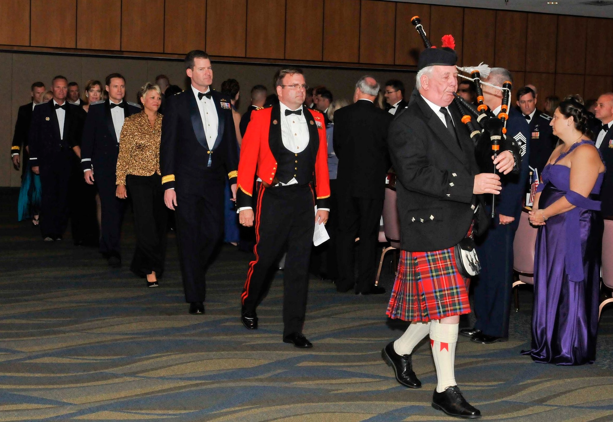 Bagpiper Terry Higbie leads the official party into the ballroom during the 87th annual Maple Leaf Mess Dinner at the Horizons Community Center at Tyndall Air Force Base, Fla., April 2. The mess celebrated the 87th anniversary of the Royal Canadian Air Force. All Canadian military members stationed at Tyndall belong to the Maple Leaf Mess, and U.S. military partners and civic leaders are invited to participate in Canada’s annual tradition. (U.S. Air Force photo by Lisa Norman) 
