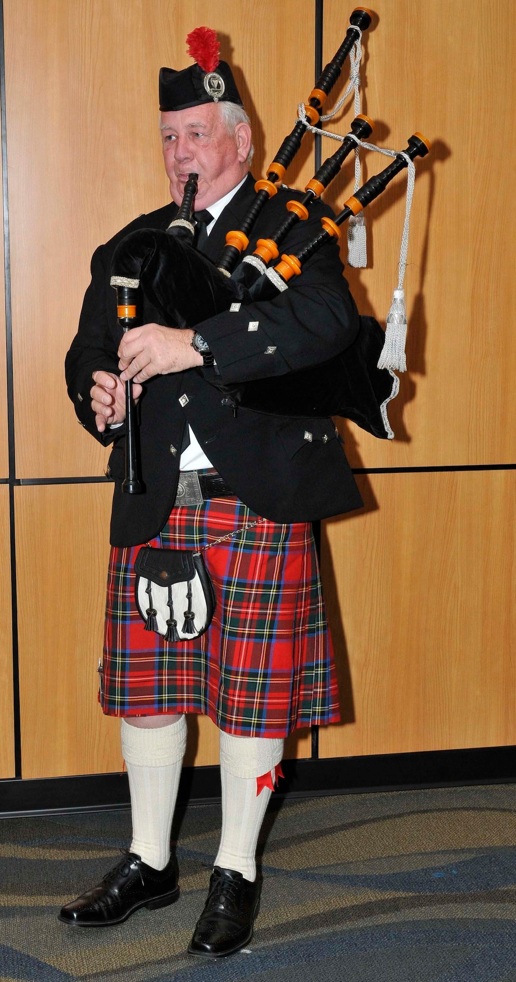 Bagpiper Terry Higbie plays a warning call for attendees of the 87th Annual Maple Leaf Mess Dinner to signify the meal will soon be served. The dinner, held April 2 at the Horizons Community Center at Tyndall Air Force Base, Fla., celebrated the 87th anniversary of the Royal Canadian Air Force. All Canadian military members stationed at Tyndall belong to the Maple Leaf Mess, and U.S. military partners and civic leaders are invited to participate in their annual tradition. (U.S. Air Force photo by Lisa Norman)