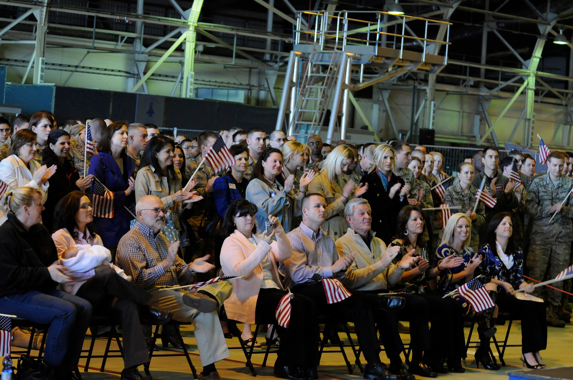 ROYAL AIR FORCE LAKENHEATH, England -- Maj. Kenneth Harney, 494th Fighter Squadron pilot and Capt. Tyler Stark, 494th Fighter Squadron weapons system officer, receive a round of applause from family (seated front row) and Liberty Airmen at RAF Lakenheath, England, after speaking about their experience in Libya on March 29, 2011.  The two crewmembers told their story of survival after the F-15E they flew crashed during Operation Odyssey Dawn.  (U.S. Air Force photo/ Staff Sgt. Connor Estes/Released)