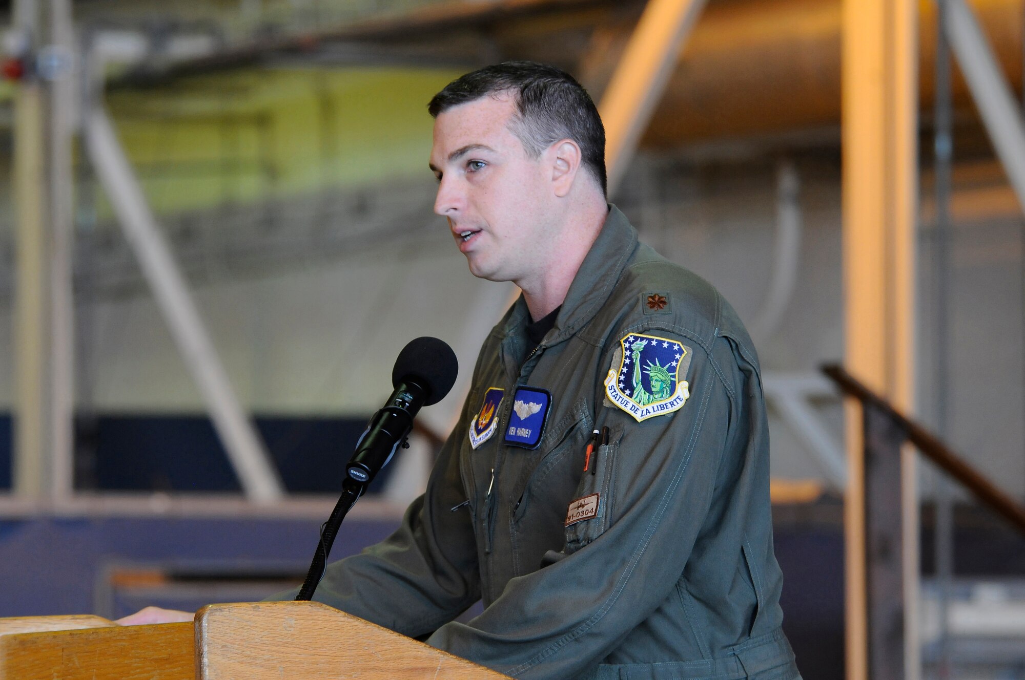 ROYAL AIR FORCE LAKENHEATH, England -- Maj. Kenneth Harney, 494th Fighter Squadron pilot, speaks to family and Liberty Airmen about his experience in Libya at RAF Lakenheath, England, March 29, 2011.  Maj. Harney told his story of survival after the F-15E he flew crashed during Operation Odyssey Dawn.  He talked about experiences ranging from ejection from the plane to being recovered by a Marine search-and-rescue team.  (U.S. Air Force photo/ Staff Sgt. Connor Estes/Released)