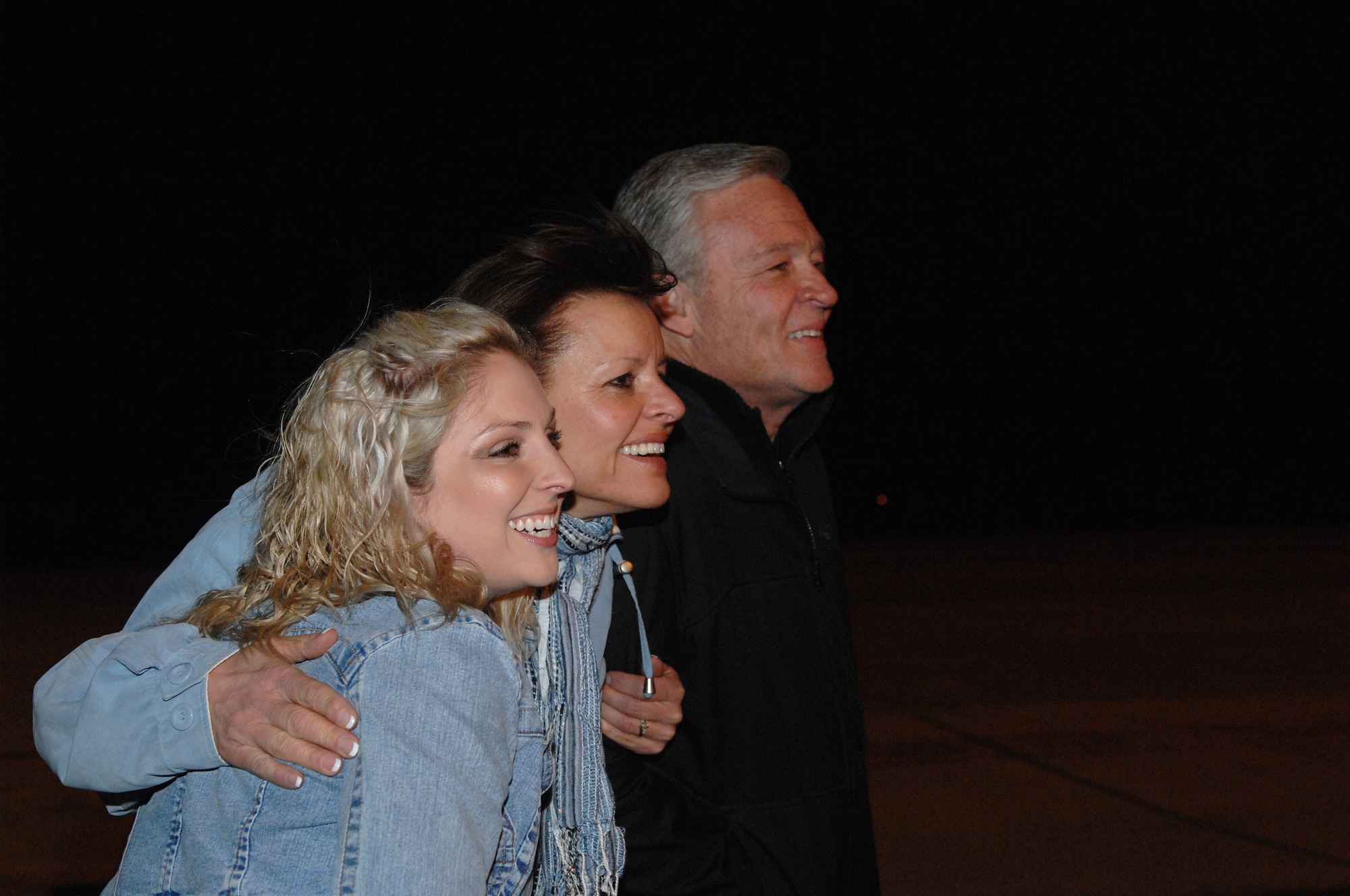 ROYAL AIR FORCE LAKENHEATH, England -- (left to right) Ana Eason Harney (wife), Dorene Stark (mother) and Bruce Stark (father) joyfully await the arrival of a C-130 transporting Maj. Kenneth Harney and Capt. Tyler Stark to RAF Lakenheath, England March 26, 2011.  The two aircrew members whose, F-15E Strike Eagle crashed in Libya during Operation Odyssey Dawn, were greeted by their family and friends.   The 48th Fighter Wing provides all-weather, day or night air superiority and air-to-ground precision combat capability as well as combat search and rescue.  (U.S. Air Force photo by Tech. Sgt. Lee A. Osberry Jr./Released)
