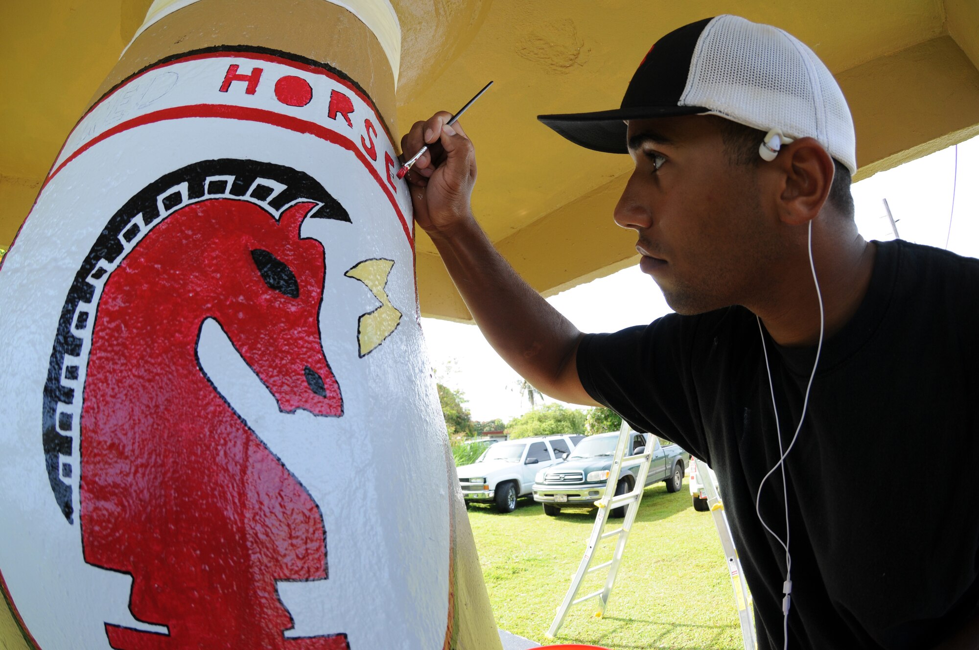 ANDERSEN AIR FORCE BASE, Guam - Staff Sgt. Cameron Pleasant, 554th RED
HORSE Squadron structures shop, works on the RED HORSE emblem on the bus
stop the squadron has adopted within the local community, April 7. Members
of the squadron have volunteered more than 100 hours to ensure the stop
looks perfect for the local school children. (U.S. Air Force photo / Senior
Airman Carlin Leslie)
