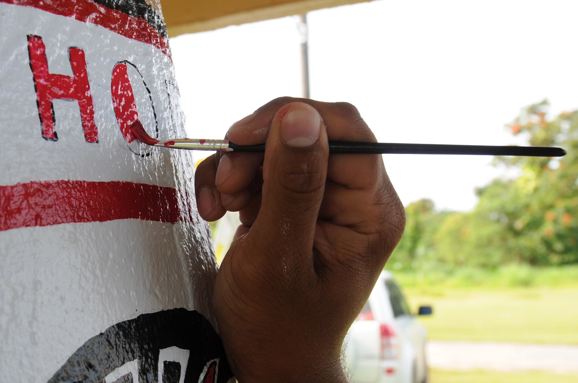 ANDERSEN AIR FORCE BASE, Guam -Staff Sgt. Cameron Pleasant, 554th RED
HORSE Squadron structures shop, pays close attention to detail while outline
the words "RED HORSE" on the bus stop the squadron adopted in Yigo, Guam,
April 7. Sergeant Pleasant took pride in his part of the wall, devoting more
than five hours to make it look perfect. (U.S. Air Force photo / Senior
Airman Carlin Leslie)

