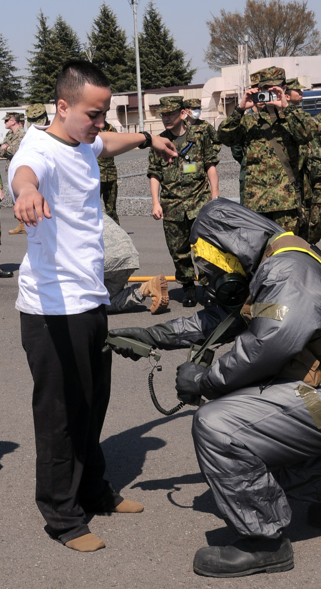 YOKOTA AIR BASE, Japan -- Japan Ground Self-Defense Force members observe Marines from Naval Support Facility, Indian Head, Md., as they demonstrate how to scan for abnormal levels of radiation at Yokota Air Base, Japan, April 6, 2011.Intial Response Force is positioned here to support Operation Tomodachi, providing a rapid response capability, and advising Japanese authorities. (U.S. Air Force photo/Airman 1st Class Krystal M. Garrett) 