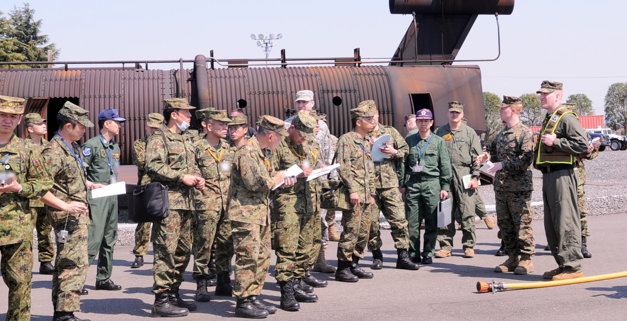 YOKOTA AIR BASE, Japan -- Japan Ground Self-Defense Force members take notes while observing the capabilities of the initial response force Marines at Yokota Air Base, Japan, April 6, 2011. IRF will support Operation Tomodachi, providing a rapid response capability and advising Japanese authorities on how to manage potential nuclear radiation. (U.S. Air Force photo/Airman 1st Class Krystal M. Garrett) 