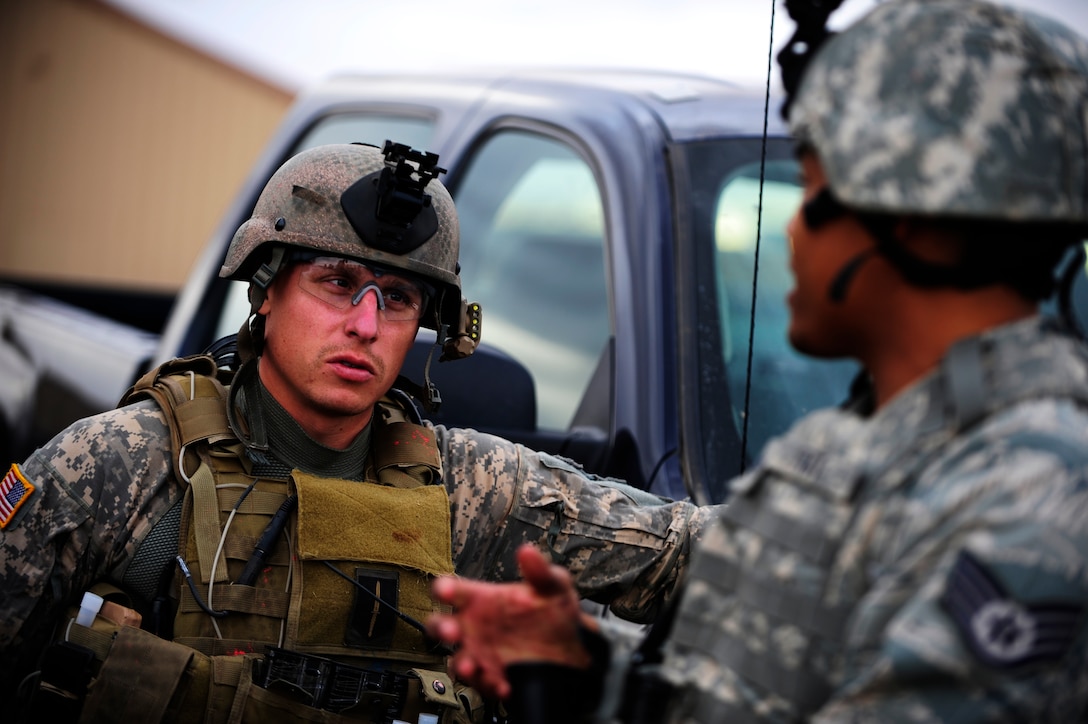 A U.S. soldier, left,  assigned to Alpha Company, 4th Battalion, 10th Special Forces Group, instructs U.S. airmen assigned to the 27th Special Operations Security Forces Squadron during Emerald Warrior 2011 at Cannon Air Force Base, N.M., March 4, 2011. Emerald Warrior is an annual two-week joint/combined tactical exercise sponsored by U.S. Special Operations Command designed to leverage lessons learned from operations Iraqi and Enduring Freedom to provide trained and ready forces to combatant commanders.