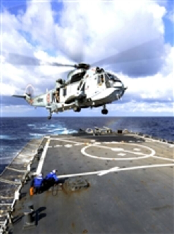 U.S. Navy flight crew members aboard the guided missile destroyer USS Stethem (DDG 63) prepare to tie down an Indian navy MK42 Sea Hawk helicopter as it lands on the ship's flight deck while underway in the Philippine Sea on April 5, 2011.  The operation was part of the joint exercise Malabar 2011, a series of training events designed to advance multinational maritime relationships and mutual security issues.  