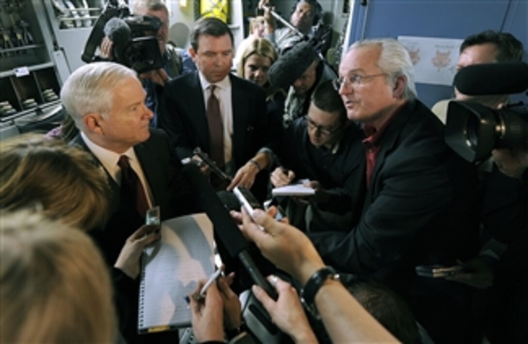 Secretary of Defense Robert M. Gates talks with members of the press onboard a Dover Air Force Base C-17 Globemaster III aircraft prior to departing Riyadh, Kingdom of Saudi Arabia, on April 6, 2011.  