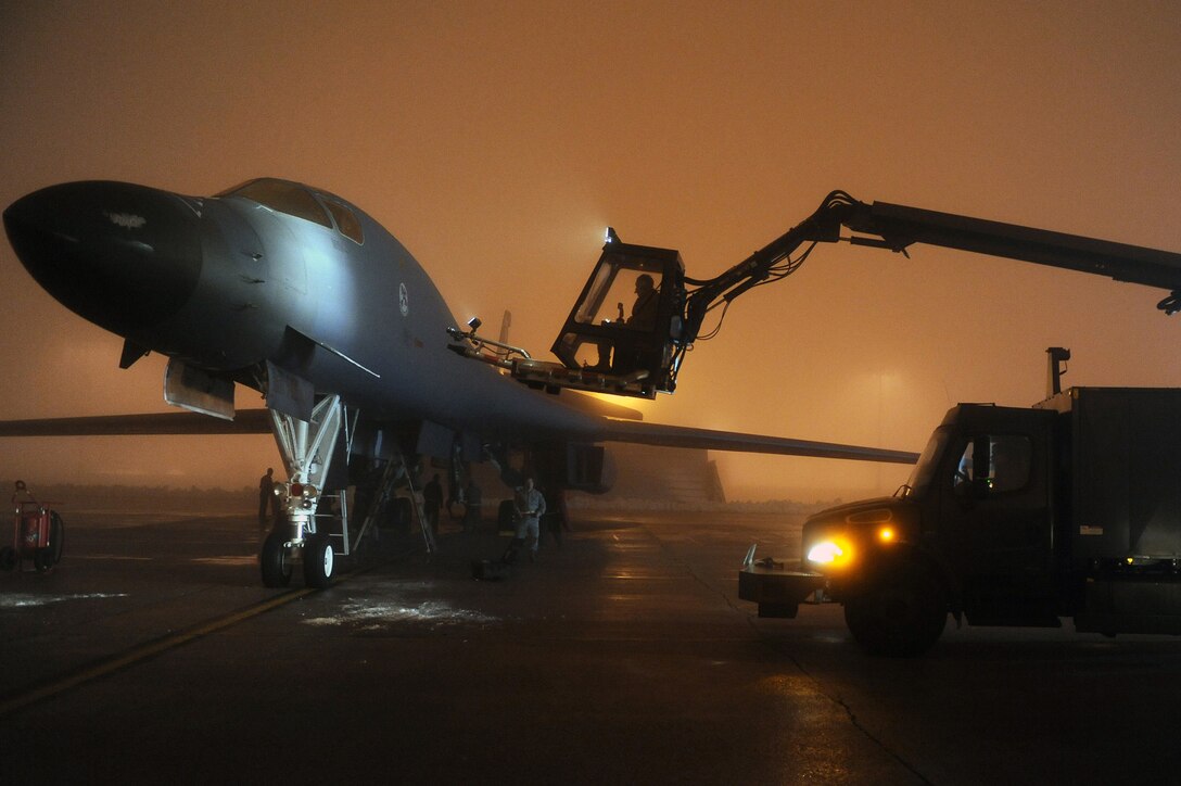 Airmen from the 34th Bomb Squadron work to de-ice a B-1B Lancer March 26, 2011, at Ellsworth Air Force Base, S.D, in preparation for a mission in support of Operation Odyssey Dawn. (U.S. Air Force photo/Senior Airman Adam Grant)
