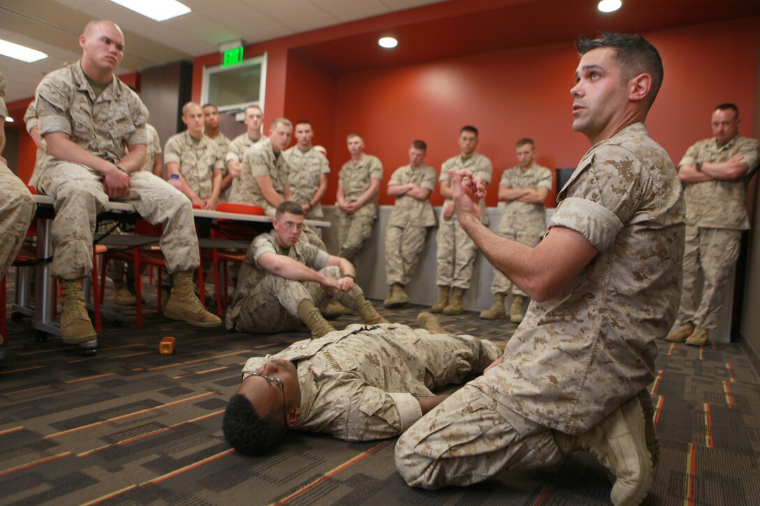 Petty Officer 2nd Class James C. Jenkins, 29, the assistant leading petty officer G3 tactical readiness and training corpsman with 1st Marine Logistics Group, describes how to assess a fallen Marine during the two-day Combat Lifesaver course here April 7. The two-day course provides Marines the knowledge to conduct advanced lifesaving procedures beyond the level of self-aid and buddy aid.
