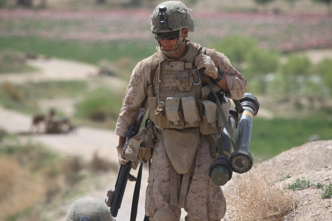 U.S. Marine Corps Lance Cpl. James T. Moreno Jr., an infantryman with 2nd Platoon, Company L, Battalion Landing Team 3/8, Regimental Combat Team 8, prepares to set himself into a security position while on patrol through the Green Zone informing locals about a incoming community meeting near Combat Outpost Ouellette, Helmand province, Afghanistan, April 8, 2011. Elements of the 26th Marine Expeditionary Unit deployed to Afghanistan to provide regional security in Helmand province in support of the International Security Assistance Force.