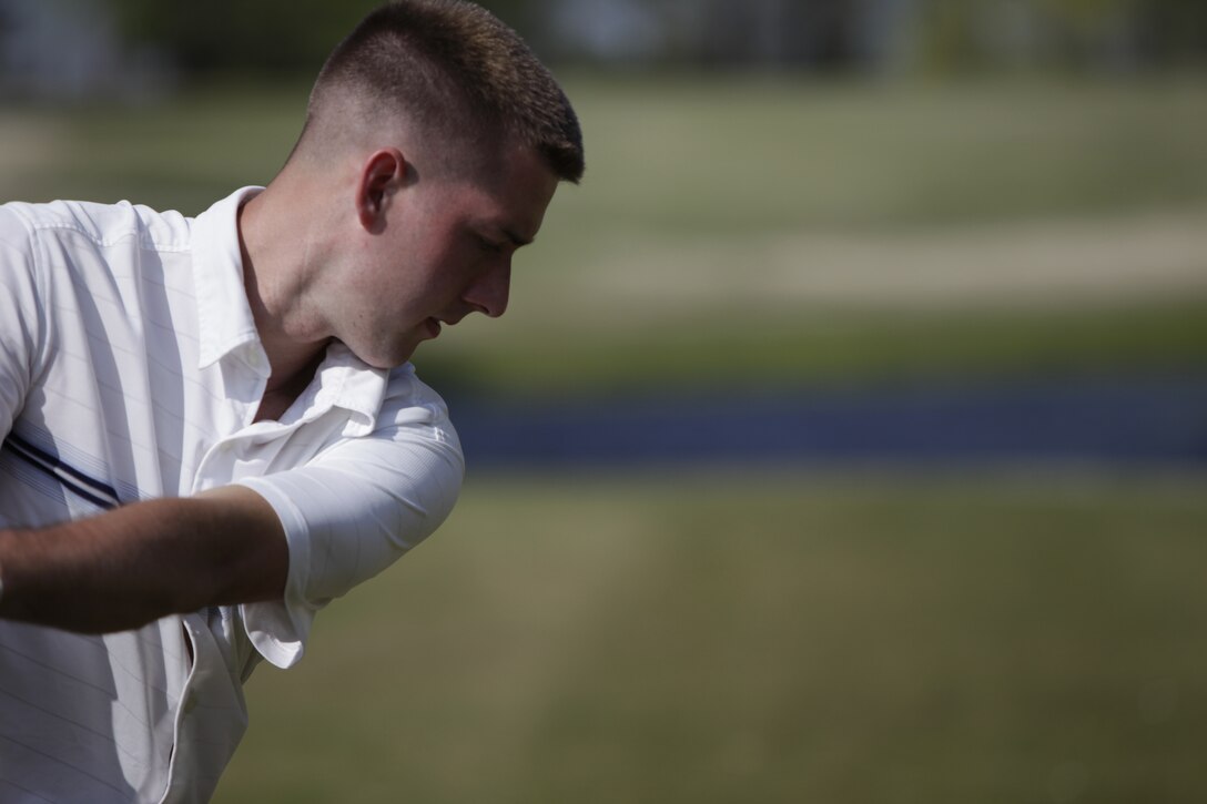 Kyle G. Butzer, an AV-8B Harrier engine mechanic with Marine Aviation Logistics Squadron 14, swings in on a tee shot at Cherry Point’s Sound of Freedom Golf Course during the air station’s annual Single Marine Program Devil Dog Open April 8. The tournament’s winning team registered a score of 59, 13 shots under the course’s par 72, and the top nine finishing teams received prizes ranging from golf gear to gift certificates redeemable at the course’s golf shop.