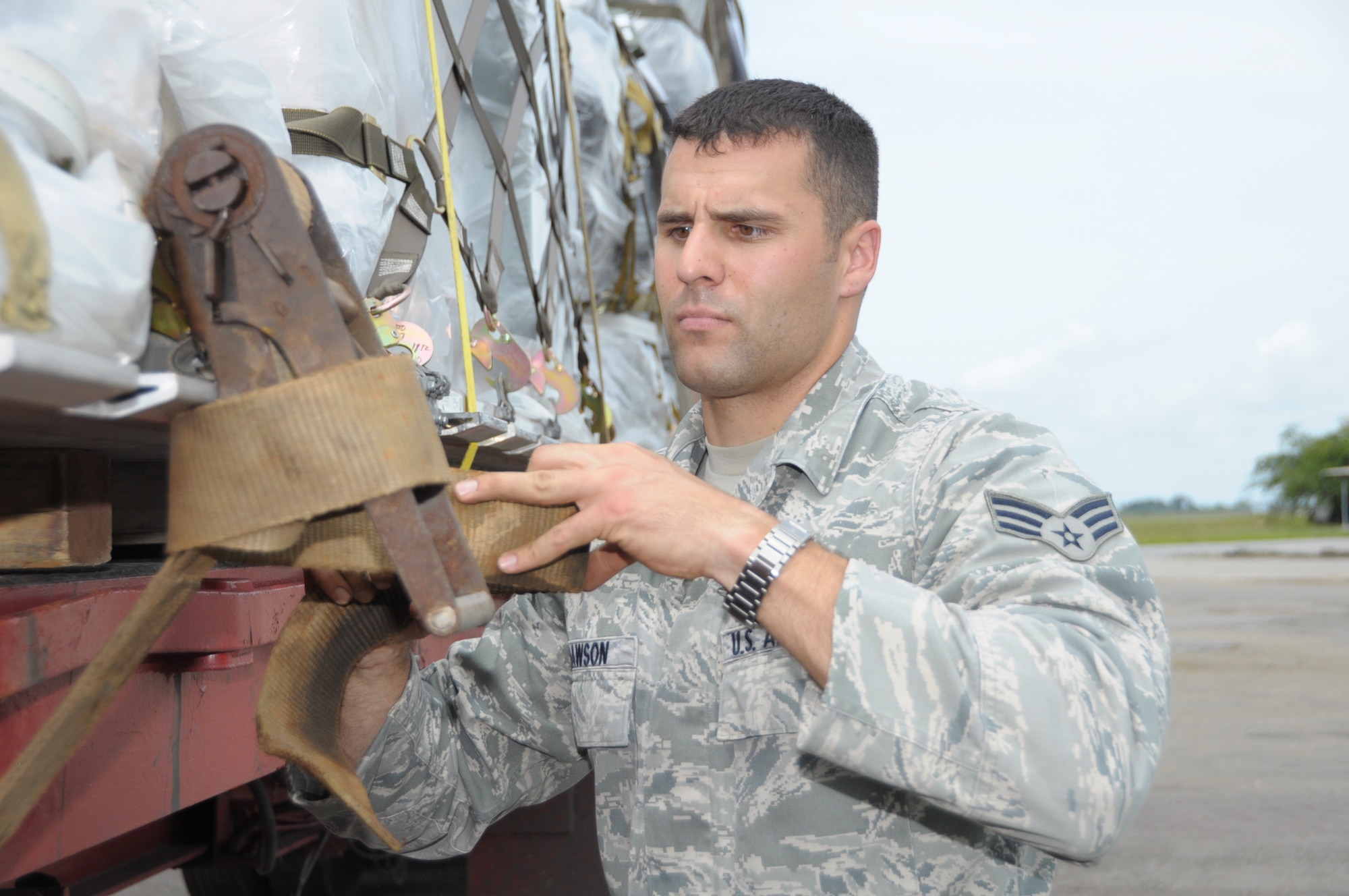 U.S. Air Force Senior Airman Nicholas Dawson, 60th Medical Group Medical Technician fastens straps on a truck delivering medical supplies to Cumuto Barracks in Trinidad and Tobago. Dawson is a part of the Expeditionary Medical Support Health Response Team in support of the Allied Forces Humanitarian Exercise/Fuerzas Aliadas or FA HUM 2011. (U.S. Air Force photo by 2d Lt Joel Banjo-Johnson/Released)
