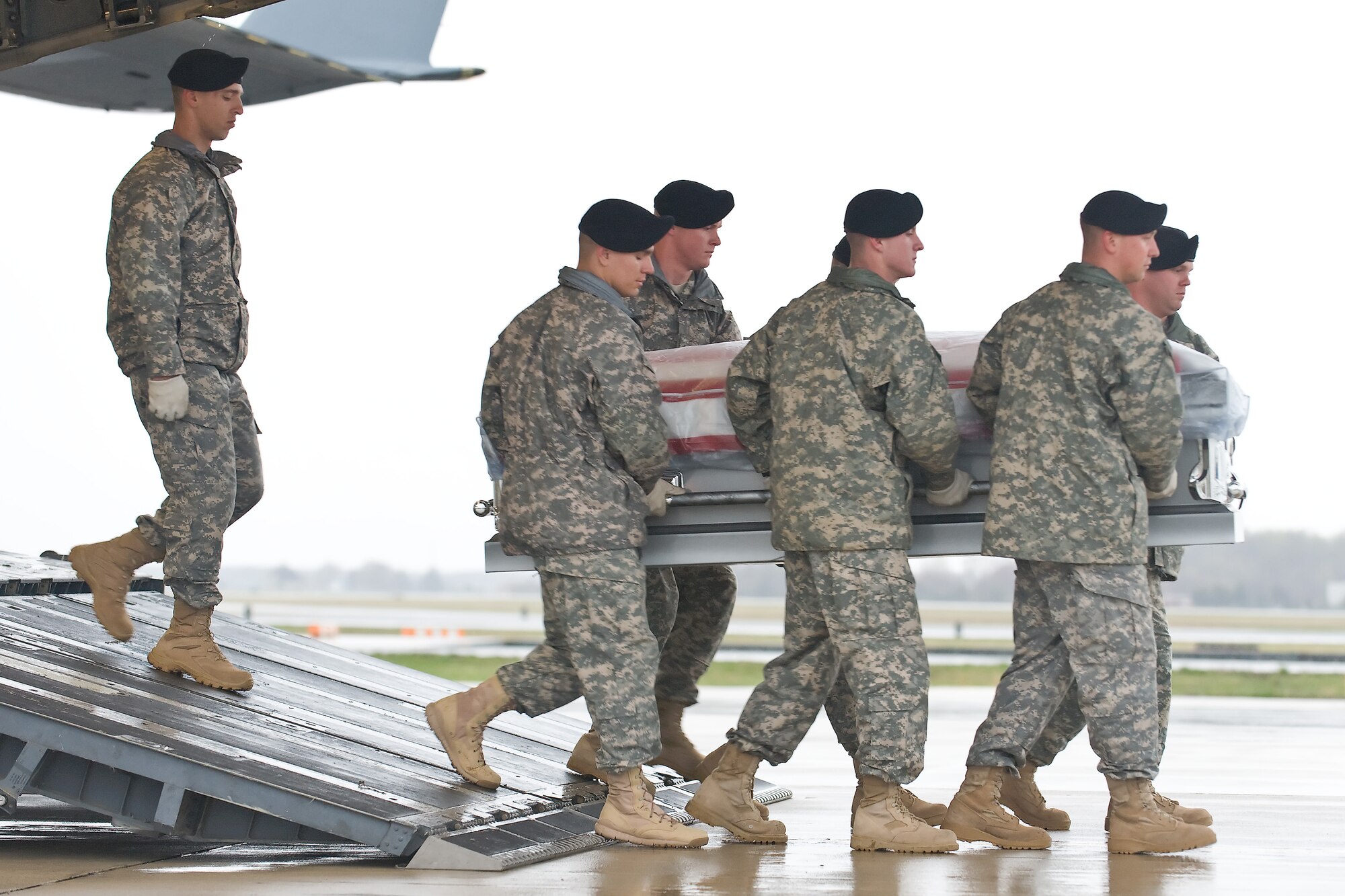 A U.S. Army carry team transfers the remains of Army Spc. Dennis C. Poulin, of Cumberland, R.I., at Dover Air Force Base, Del., April 8, 2011. Poulin was assigned to the 1st Battalion, 181st Infantry Regiment, Massachusetts National Guard, Milford, Mass. (U.S. Air Force photo/Roland Balik)