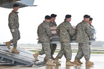 A U.S. Army carry team transfers the remains of Army Spc. Dennis C. Poulin, of Cumberland, R.I., at Dover Air Force Base, Del., April 8, 2011. Poulin was assigned to the 1st Battalion, 181st Infantry Regiment, Massachusetts National Guard, Milford, Mass. (U.S. Air Force photo/Roland Balik)