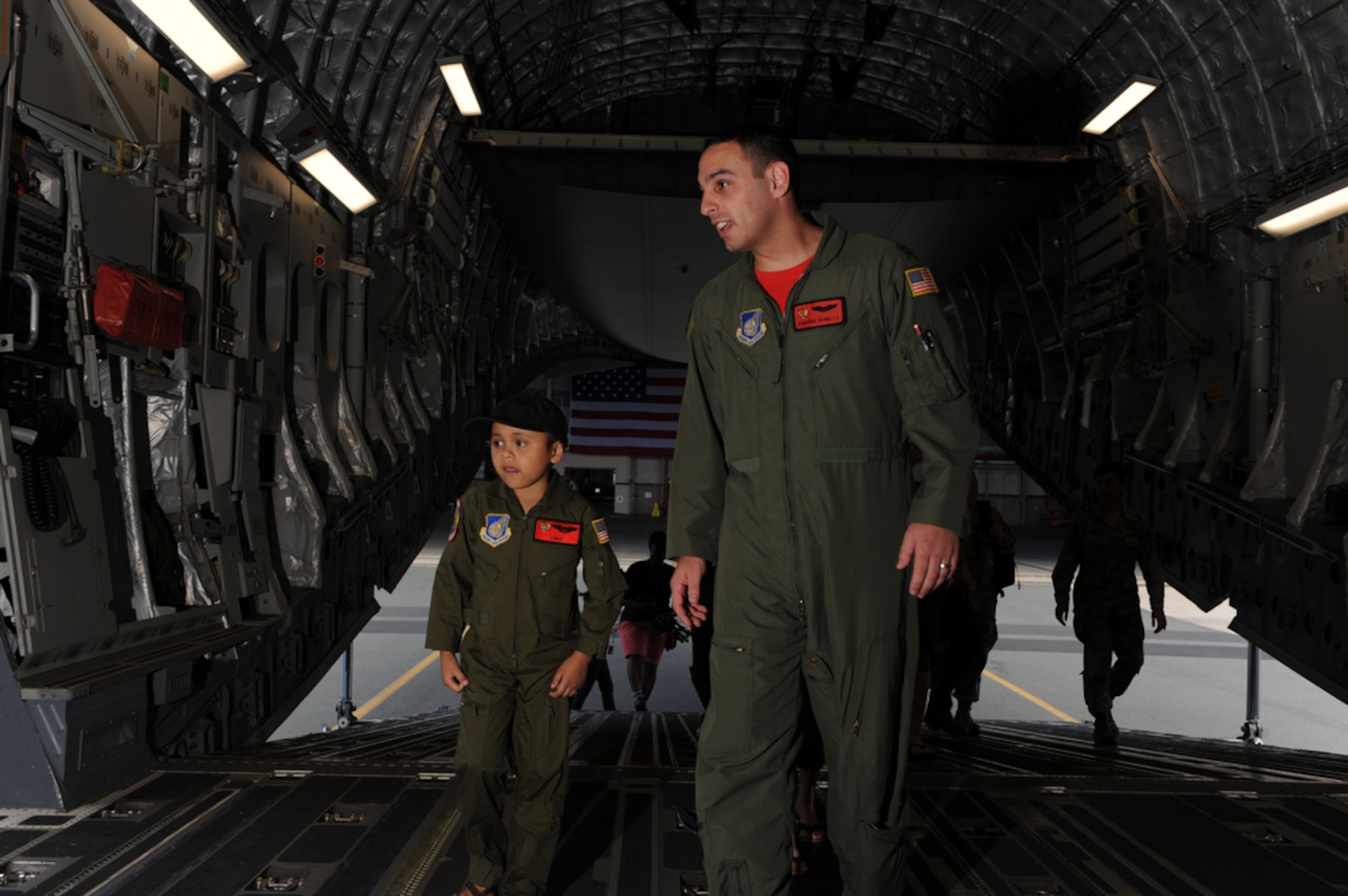 Seven year-old Jonah "J-Boy" Kalaikai and 535th Airlift Squadron pilot Captain Domonic Bonello as he explains the insides of a C-17 Globemaster III while at the Joint Base Pearl Harbor-Hickam, Hawaii on April 2, 2010. J-Boy was invited to JBPHH to participate in the "Pilot for a Day" program which is a partnership between Kapi'olani Medical Center and the 15th Airlift Wing that gives a special day to a child that is dealing with a serious or chronic condition. J-Boy was diagnosed with Acute Myeloid Leukemia at age two and has been in and out of remission five times since then. (U.S. Air Force photo/Tech Sgt. Cohen A. Young)
