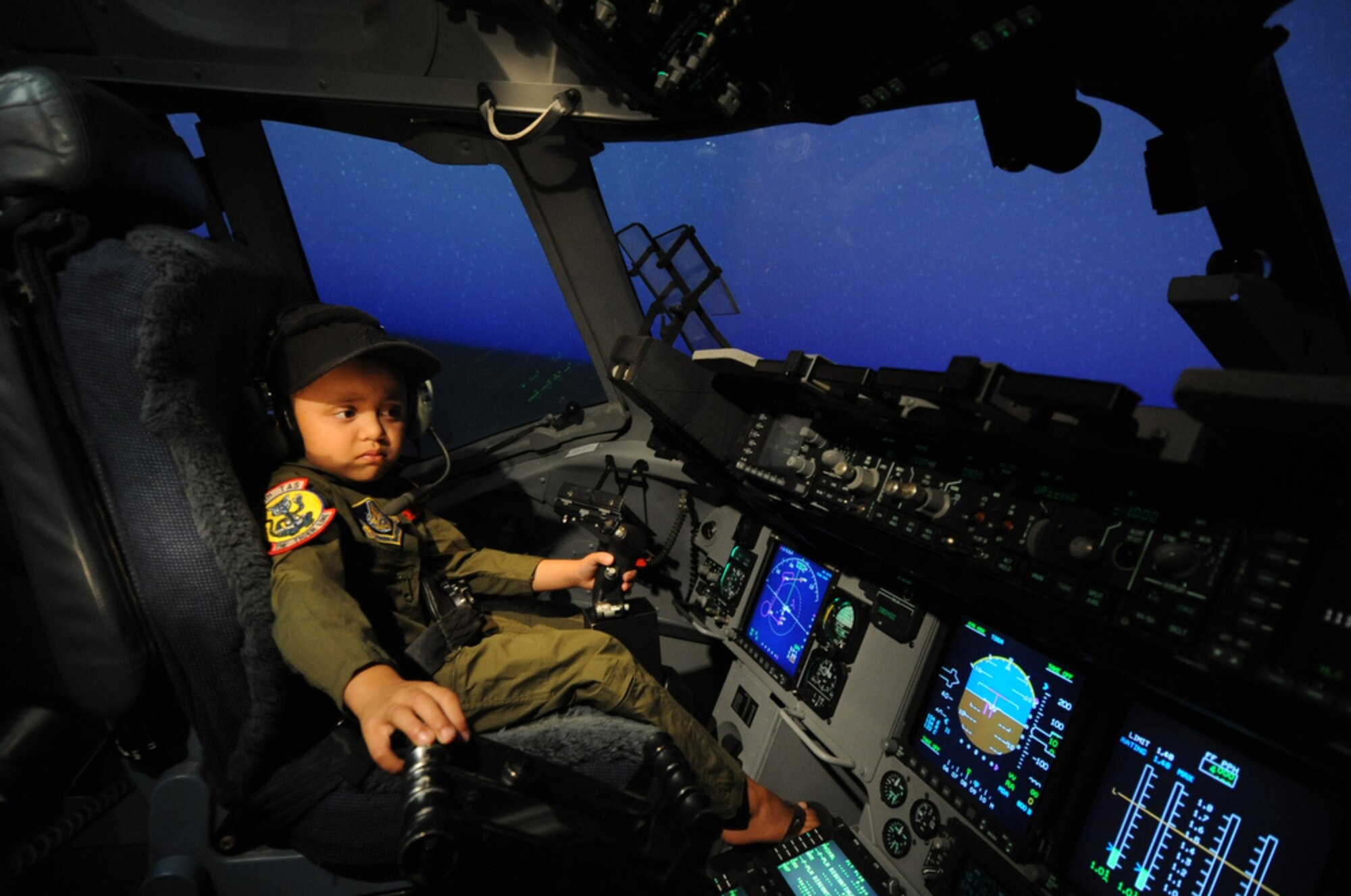 Seven year-old Jonah Kalaikai handles the throttle while inside a C-17 Globemaster III simulator while at the 535th Airlift Squadron, Joint Base Pearl Harbor-Hickam, Hawaii on April 2, 2010. Jonah was invited to JBPHH to participate in the "Pilot for a Day" program which is a partnership between Kapi'olani Medical Center and the 15th Airlift Wing that gives a special day to a child that is dealing with a serious or chronic condition. Jonah was diagnosed with Acute Myeloid Leukemia at age two and has been in and out of remission five times since then. (U.S. Air Force photo/Tech Sgt. Cohen A. Young)