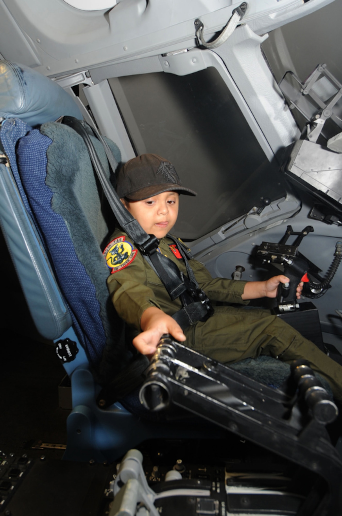 Seven year-old Jonah Kalaikai handles the throttle while inside a C-17 Globemaster III simulator while at the 535th Airlift Squadron, Joint Base Pearl Harbor-Hickam, Hawaii on April 2, 2010. Jonah was invited to JBPHH to participate in the "Pilot for a Day" program which is a partnership between Kapi'olani Medical Center and the 15th Airlift Wing that gives a special day to a child that is dealing with a serious or chronic condition. Jonah was diagnosed with Acute Myeloid Leukemia at age two and has been in and out of remission five times since then. (U.S. Air Force photo/Tech Sgt. Cohen A. Young)