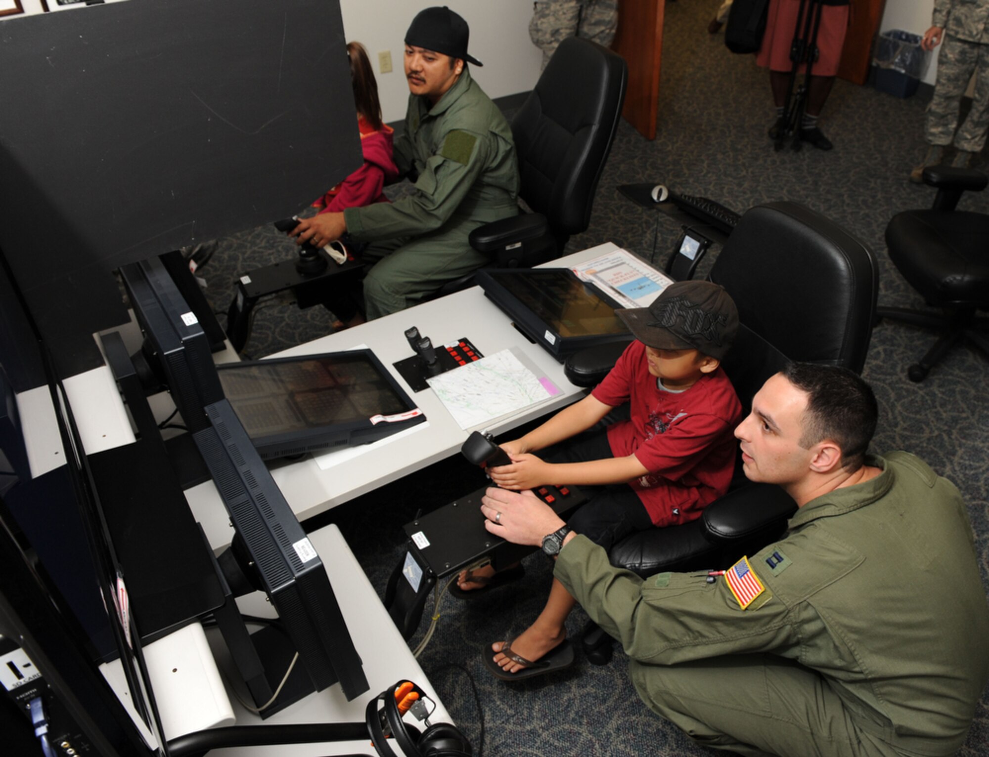 Seven year-old Jonah Kalaikai receives a little flight training from Captain Domonic Bonello of the 535th Airlift Squadron, Joint Base Pearl Harbor-Hickam, Hawaii on April 2, 2010. Jonah was invited to JBPHH to participate in the "Pilot for a Day" program as part of a partnership between Kapi'olani Medical Center and the 15th Airlift Wing to give a special day to a child that is dealing with a serious or chronic condition. Jonah was diagnosed with Acute Myeloid Leukemia at age two and has been in and out of remission five times since then. (U.S. Air Force photo/Tech Sgt. Cohen A. Young)
