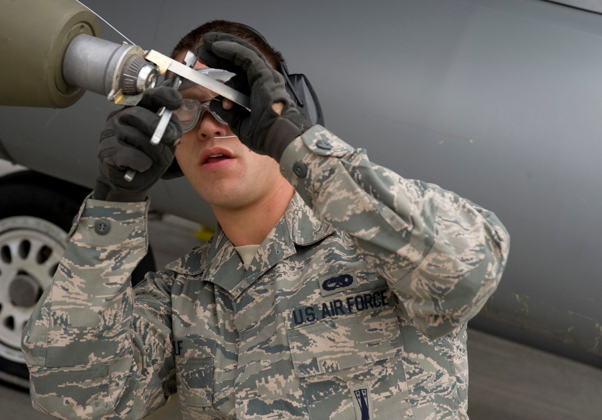 NELLIS AIR FORCE BASE, Nev.-- Senior Airman Lucas Wolf, 57th Aircraft Maintenance Squadron, load crew member, does the finishing checks to a Mark-82 bomb after loading it onto an F-16 during the 1st quarterly weapons load competition  April 8. Weapons load competitions are conducted quarterly to keep Airmen sharp and recognize superior performers. Weapons load teams are evaluated for their use of the checklist, safety, and overall speed. (U.S. Air Force photo by Airman 1st Class Matthew Lancaster)