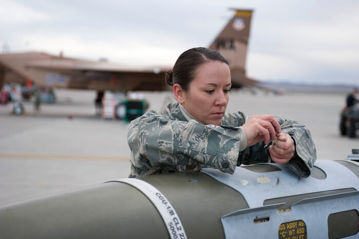 NELLIS AIR FORCE BASE, Nev.-- Airman1st Class Sara Gatewood, 57th Aircraft Maintenance Squadron, weapons load crew member, performs munitions preparation on a bomb during the 1st quarterly weapons load competition April 8. Weapons load competitions are conducted quarterly to keep Airmen sharp and recognize superior performers. Weapons load teams are evaluated for their use of the checklist, safety, and overall speed. (U.S. Air Force photo by Airman 1st Class Matthew Lancaster)
