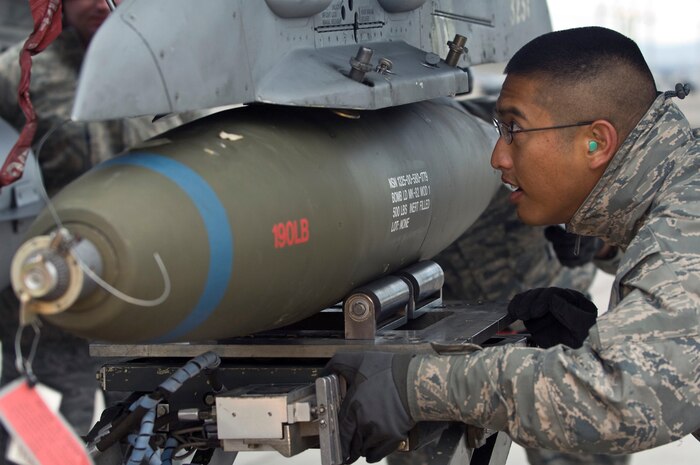 NELLIS AIR FORCE BASE, Nev.-- Staff Sgt. Jason Spears, 57th Aircraft Maintenance Squadron, weapons load crew chief, loads a Mark-82 bomb onto an F-16 during the 1st quarterly weapons load competition April 8. Weapons load competitions are conducted quarterly to keep Airmen sharp and recognize superior performers. Weapons load teams are evaluated for their use of the checklist, safety, and overall speed. (U.S. Air Force photo by Airman 1st Class Matthew Lancaster)