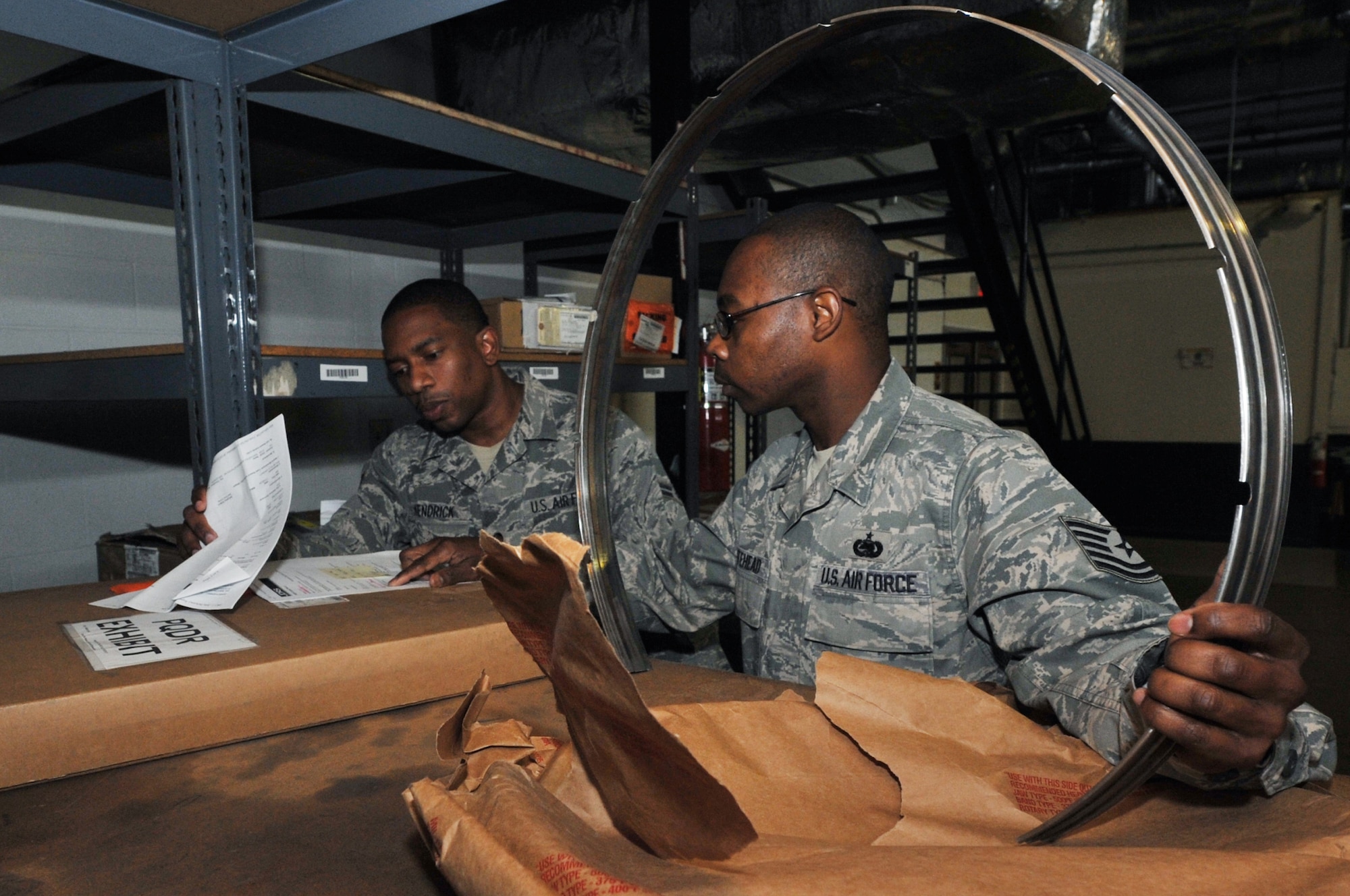 Airman 1st Class Keon Kendrick, a 19th Logistics Readiness Squadron inspection journeymen, and Tech. Sgt. Terrance Whitehead, a 19th LRS  NCO in charge of inspection, inspect and  match a part with the quality deficiency report March 30. The QDR is inspected and reviewed daily to ensure parts are shipped to the right place for the appropriate disposition. (U.S. Air Force photo by Airman 1st Class Rusty Frank)