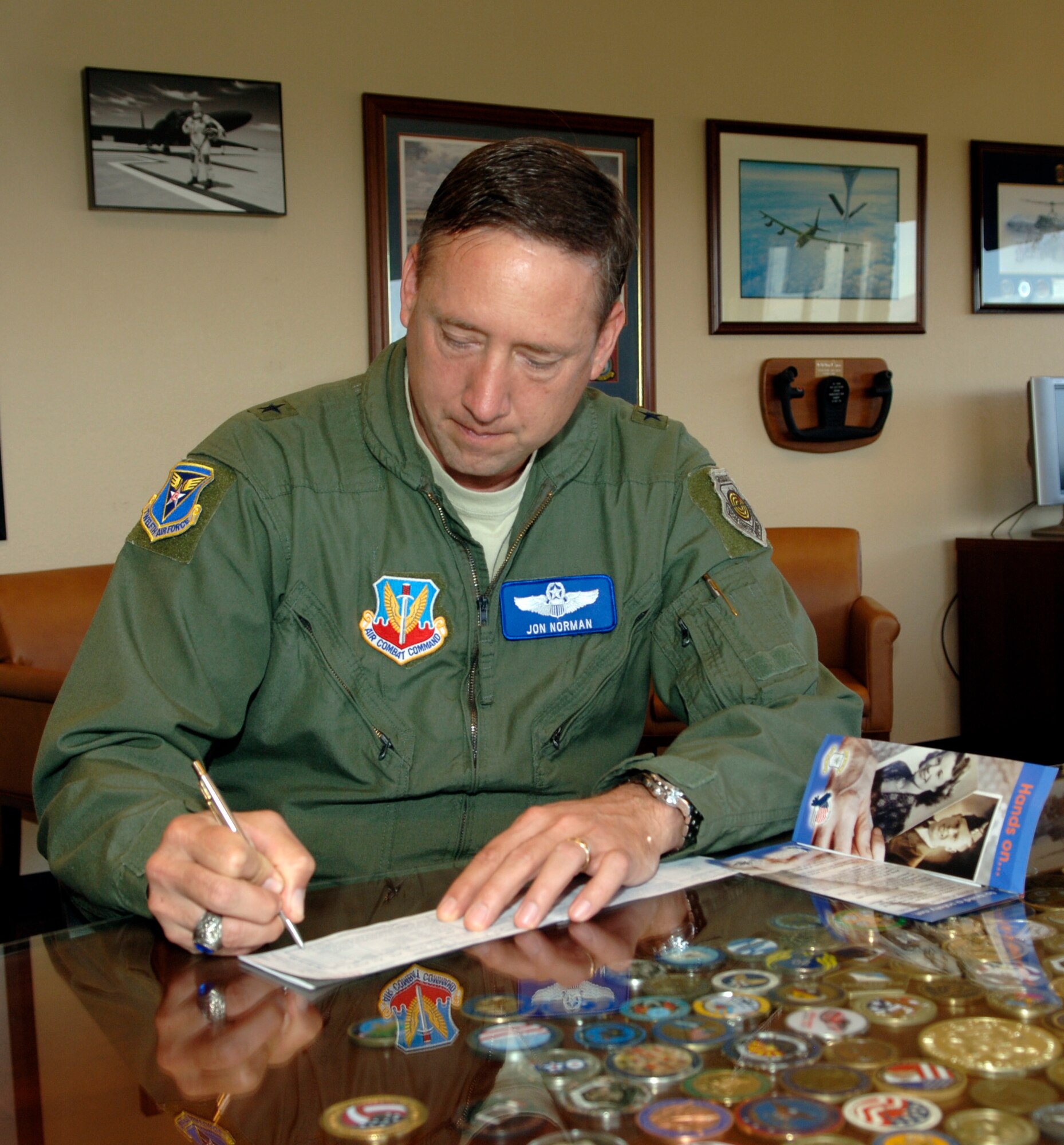 DAVIS-MONTHAN AIR FORCE BASE, Ariz. - Brig. Gen. Jon Norman, 12th Air Force (Air Forces Southern) vice
commander, signs an Air Force Assistance Fund pledge form Mar. 31. (U.S. Air
Force photo/Tech. Sgt. Eric Petosky)
