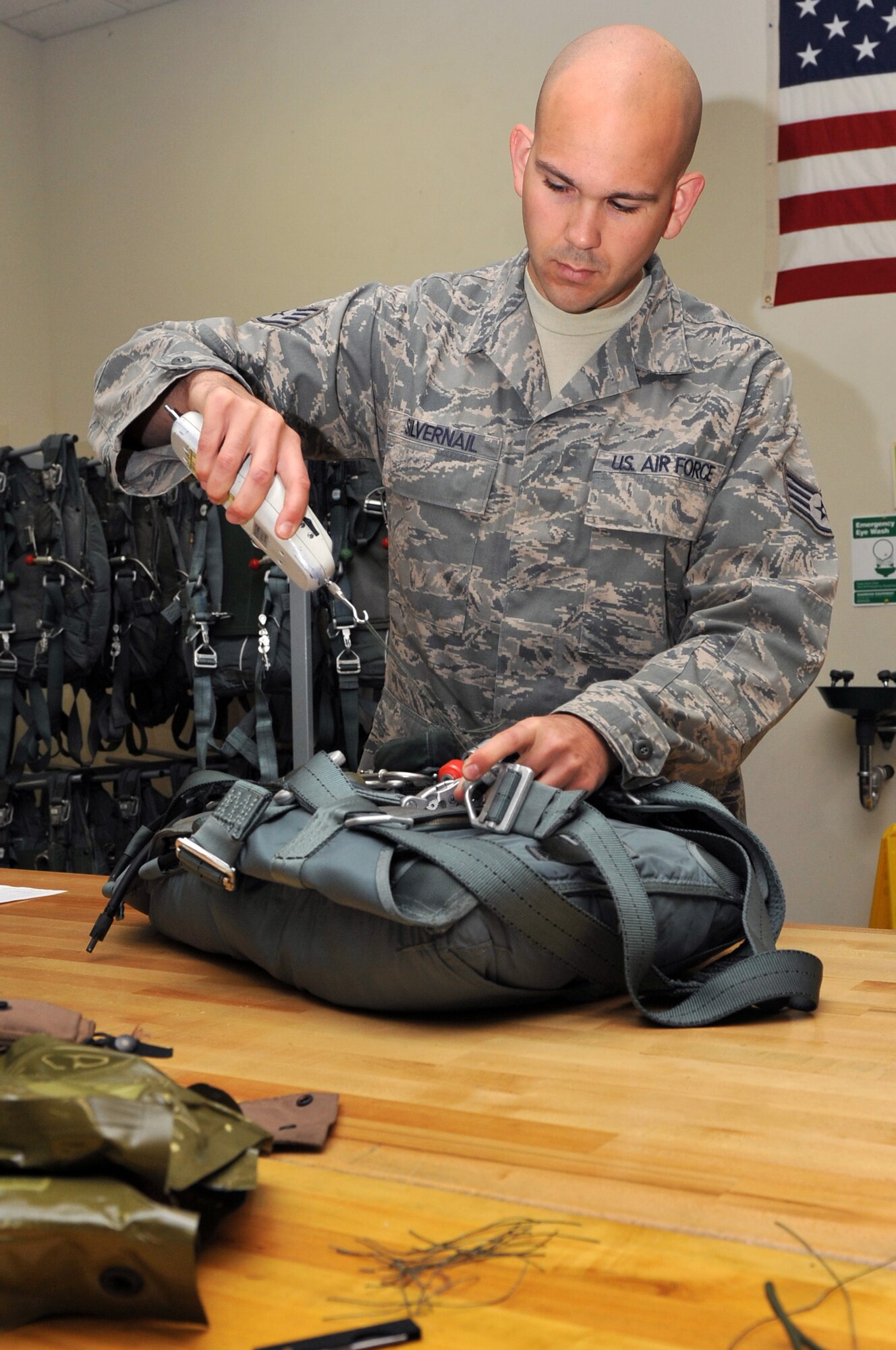 Staff Sgt James Silvernail, a 19th Operations Support Squadron aircrew flight crew equipment supervisor, performs a quality assurance check on a parachute April 5, 2011, at Little Rock Air Force Base, Ark. The Richmond, Ohio, native led his section in configuring and preparing 14 aircraft for ROCKEX missions. (U.S. Air Force photo by Airman 1st Class Rusty Frank)