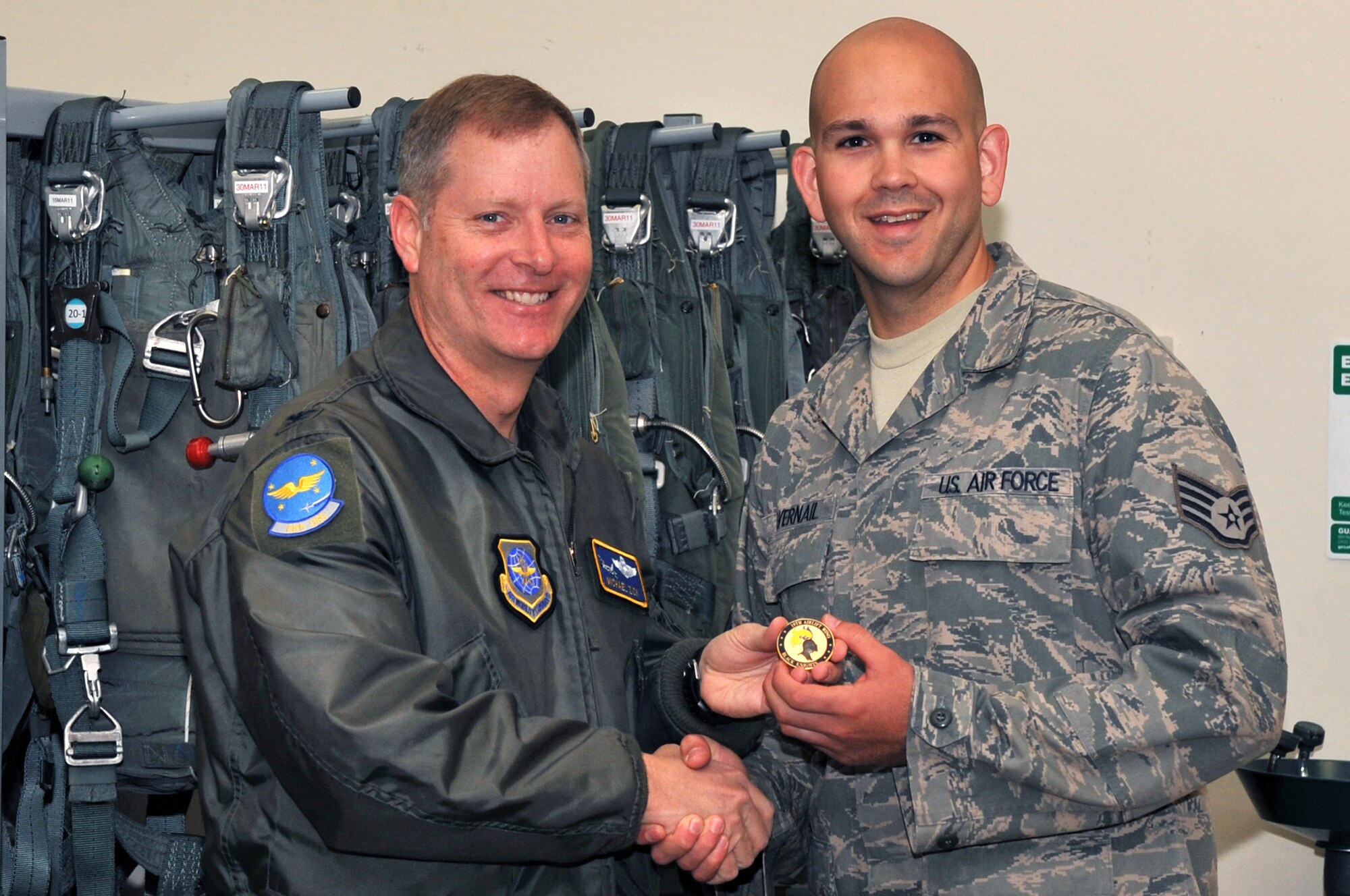 Col. Michael Zick, 19th Airlift Wing vice commander, presents Staff Sgt. James Silvernail, a 19th Operations Support Squadron aircrew flight crew equipment supervisor, with a coin April 5, 2011, at Little Rock Air Force Base, Ark. Sergeant Silvernail was an  “outstanding performer,” during the March 2011 Operational Readiness Exercise. (U.S. Air Force photo by Airman 1st Class Rusty Frank)