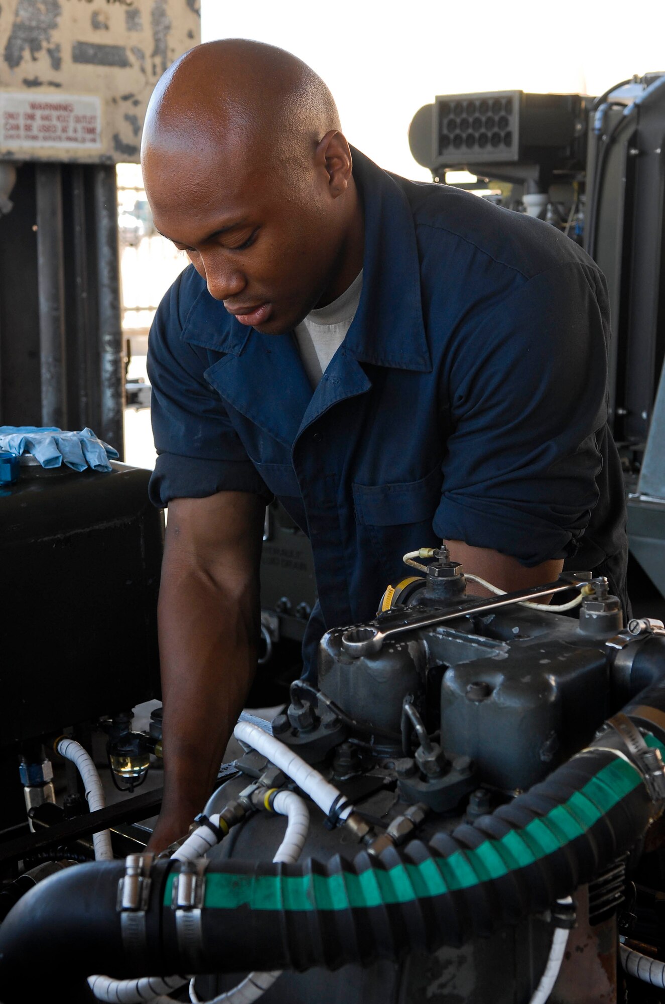 Airman 1st Class Jason Ryan, 56th Equipment Maintenance Squadron Aerospace Ground Equipment journeyman, prepares to install a pump into a munitions handling unit at Luke Air Force Base March 30. The MHU is a tool used to support the aircraft in providing handling, movement, installation, arming, loading and downloading of air launched weapons.  (U.S. Air Force photo/Senior Airman Darlene Seltmann)