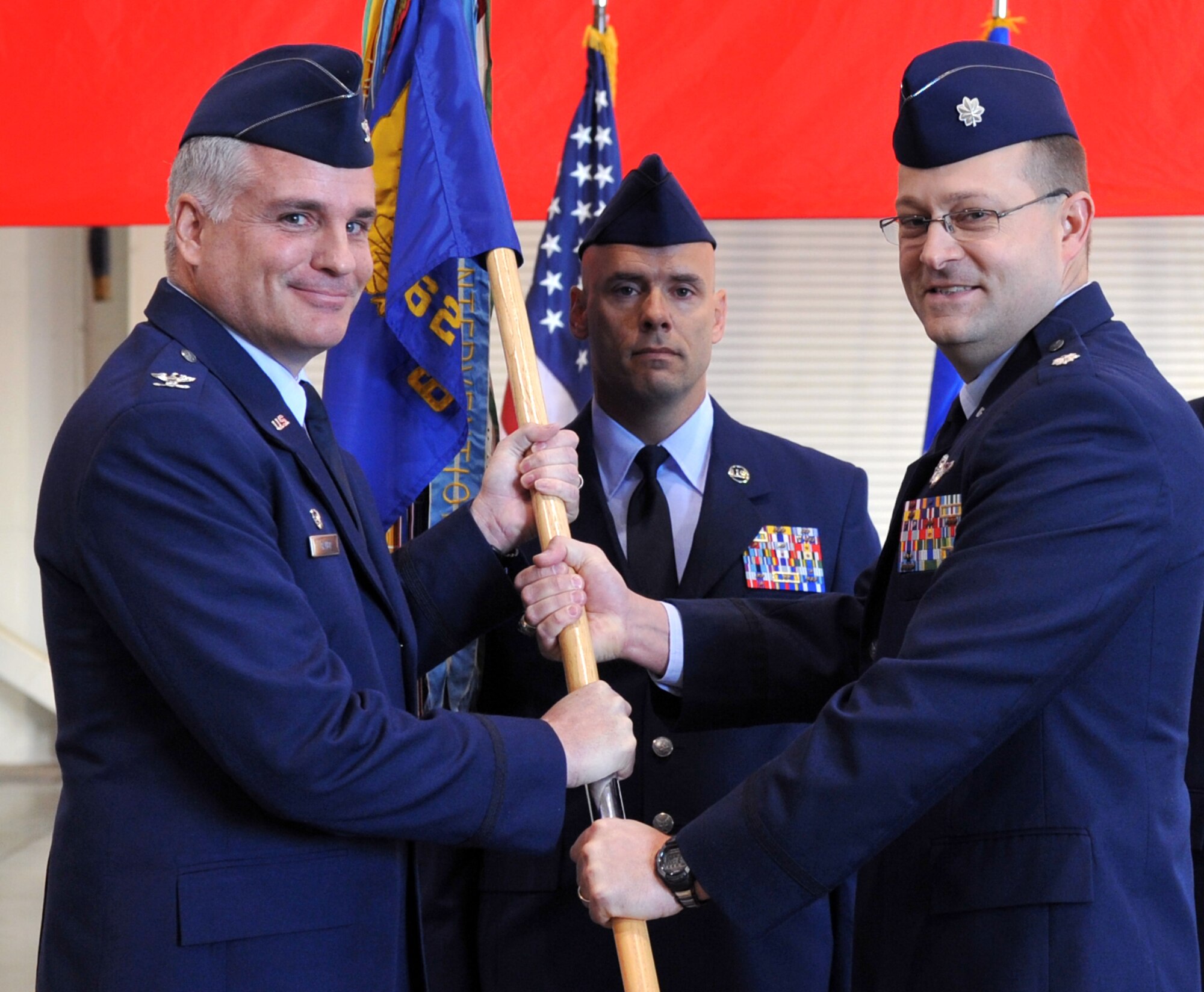 Lt. Col. Michael Nelson (right) accepts the 62nd Airlift Squadron guidon from Col. Michael Bauer, 314th Operations Group commander, and as such, command of the unit April 5, 2011, at Little Rock Air Force Base, Ark. The squadron is the world's largest C-130 Formal Training Unit and conducts 56 missions a week, training 1,370 combat airlifters annually across four crew positions destined for worldwide deployment locations. (U.S. Air Force photo by Airman 1st Class Rusty Frank)