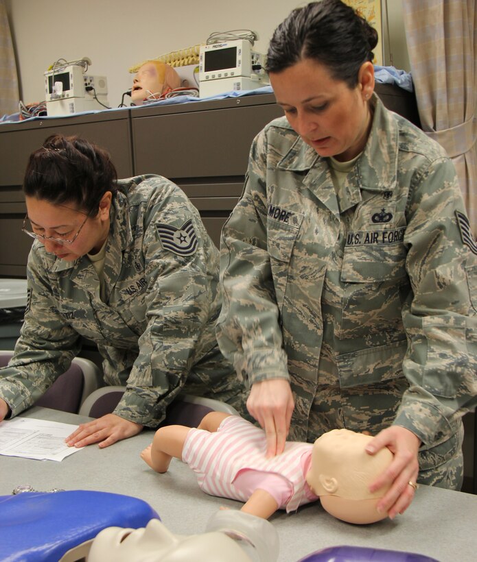 Tech. Sgt. Barbara Gilmore gives chest compressions to an infant training aid while Tech. Sgt. Michele Ortiz records the results.  Using simulated patients helps Air Force Reservists maintain their medical proficiency skills.   Both NCOs are assigned to the 932nd Medical Squadron, located at Scott Air Force Base, IL.  (U.S. Air Force photo/Tech. Sgt. Dan Oliver)  