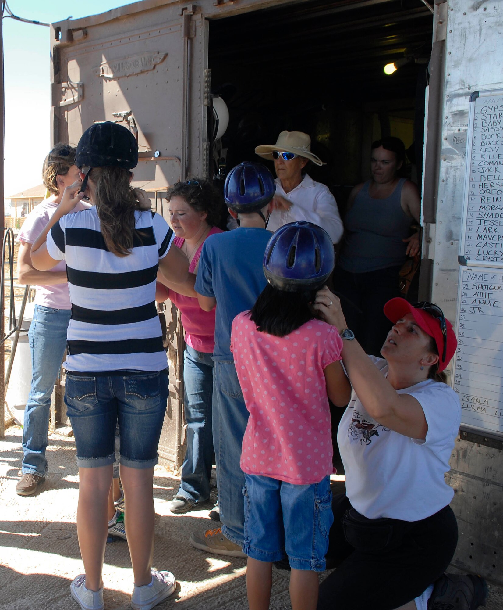 Children put on helmets before interacting with the horses April 3 during the Hearts Apart event at Sunset Ranch in Buckeye, Ariz. In order to accommodate more children the event was split between two locations, one at Sunset Ranch and the other at Horses Help, in Northern Phoenix, which is a therapeutic riding facility. (U.S. Air Force photo/Senior Airman Darlene Seltmann)
