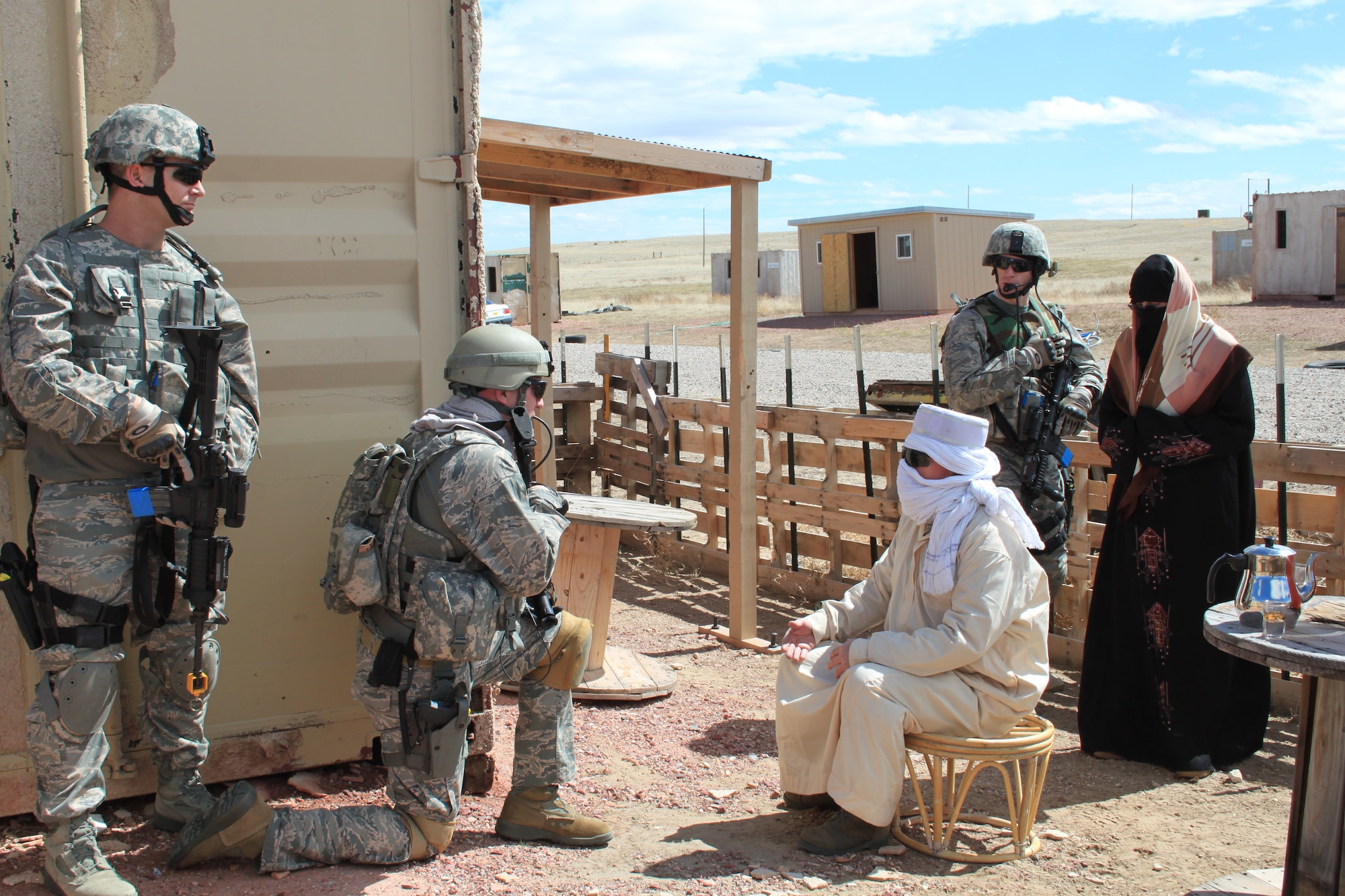 710th Security Forces members Tech. Sgt. Donald Williams (middle), Staff Sgt. David Aerne (left) and Tech. Sgt. Philip Boyles (right) meet with a sheik of a mock Afghanistan village at Camp Guernsey, Wyo., as part of a training exercise. During the meeting, Sergeant Williams discussed the needs of the village with the sheik to determine the aid coalition forces could provide. (U.S. Air Force photo by Staff Sgt. Desiree Economides)