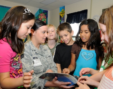 Senior Airman Rachel Meyer, 902nd Communications Squadron, reads to second graders at the Schertz Elementary School in Schertz, Texas, April 8. Military members from Ft. Sam Houston, Randolph AFB, and Lackland AFB visited Schertz Elementary School as part of a Joint Base San Antonio initiative to visit schools in the area to encourage reading. (U.S. Air Force Photo/Don Lindsey)